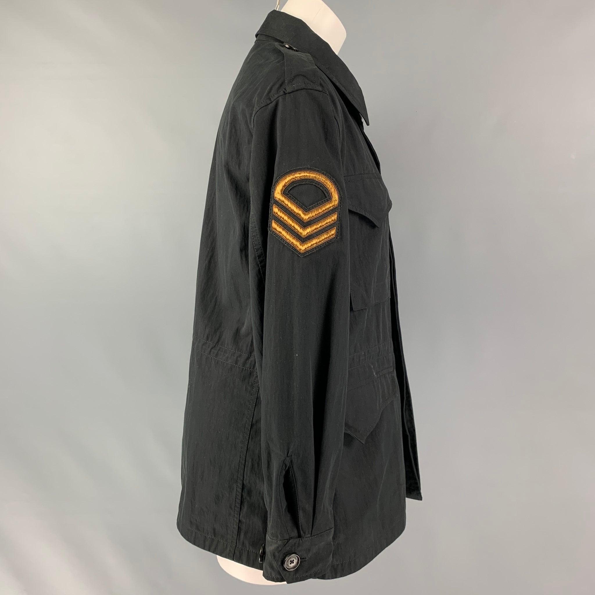 RALPH LAUREN COLLECTION by jacket comes in a black twill cotton blend featuring a gold patch details, military style, drawstring at waist, and a hidden button closure. Made in Italy.Good Pre-Owned Condition. Moderate fading Marks. AS IS
  

Marked: 