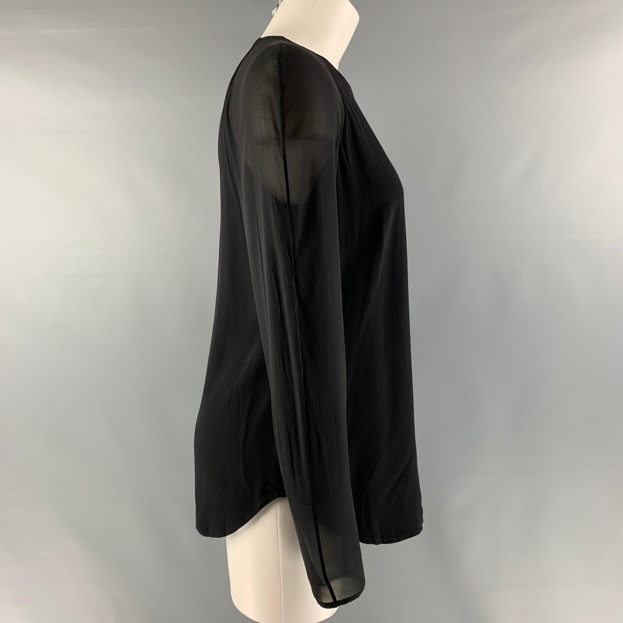 RALPH LAUREN 'BLACK LABEL by' raglan long sleeve blouse comes in a black acetate and viscose featuring see through sleeves and an invisible zipper closure at center back. Made in USA.

Very Good Pre-Owned Condition. Moderate marks at back.
Marked: