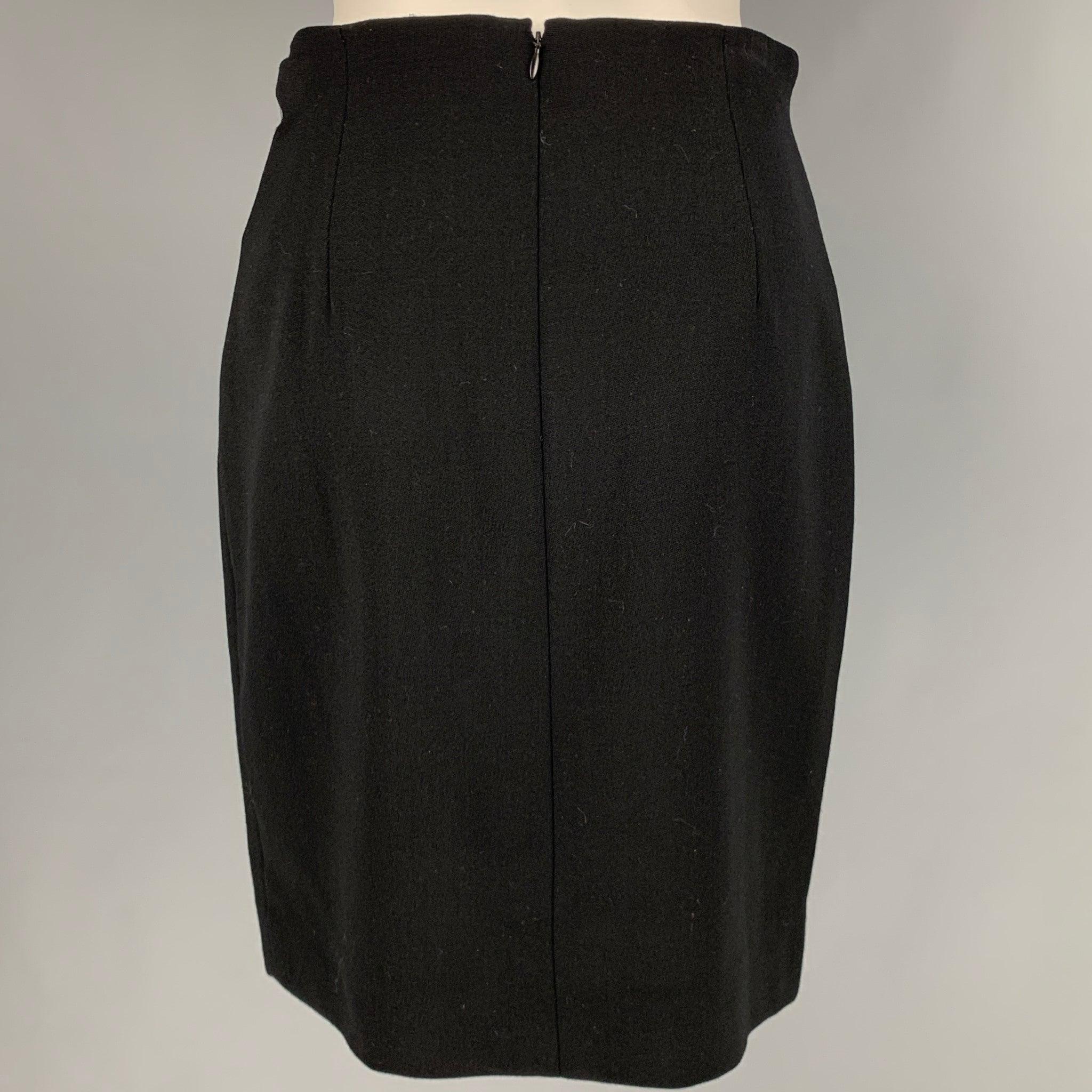 RALPH LAUREN skirt
in a
black wool fabric featuring a below knee length, pencil style, and back zipper closure. Made in USA.Excellent Pre-Owned Condition. 

Marked:   8 

Measurements: 
  Waist: 27.5 inches Hip: 35 inches Length: 20.5 inches 
  
  
