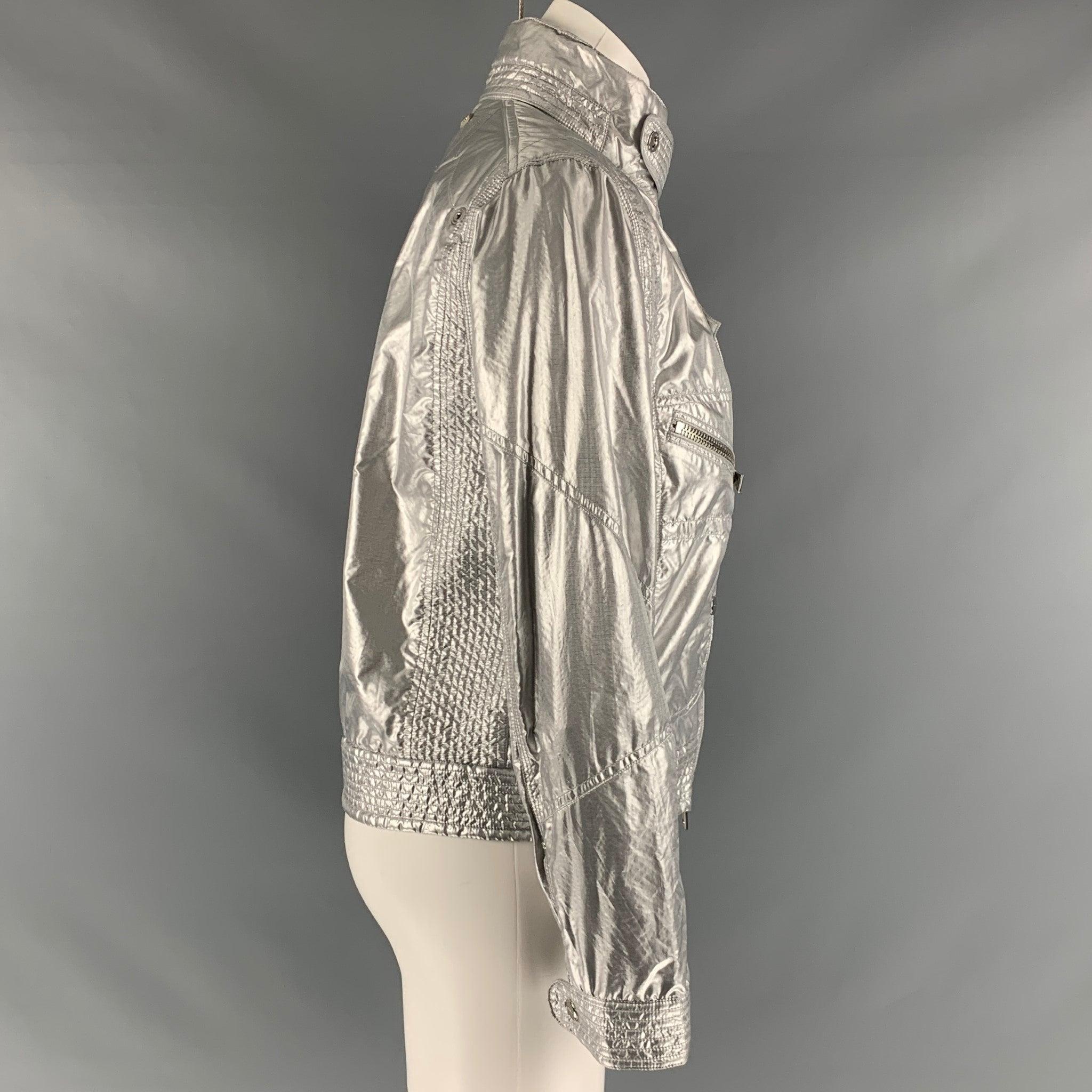 RALPH LAUREN BLACK LABEL jacket comes in a silver tone metallic nylon blend featuring a high neck, zipper pockets, silver tone hardware, and a full zip up closure. Excellent Pre- Owned Material. 

Marked:   8 

Measurements: 
 
Shoulder: 16 inches