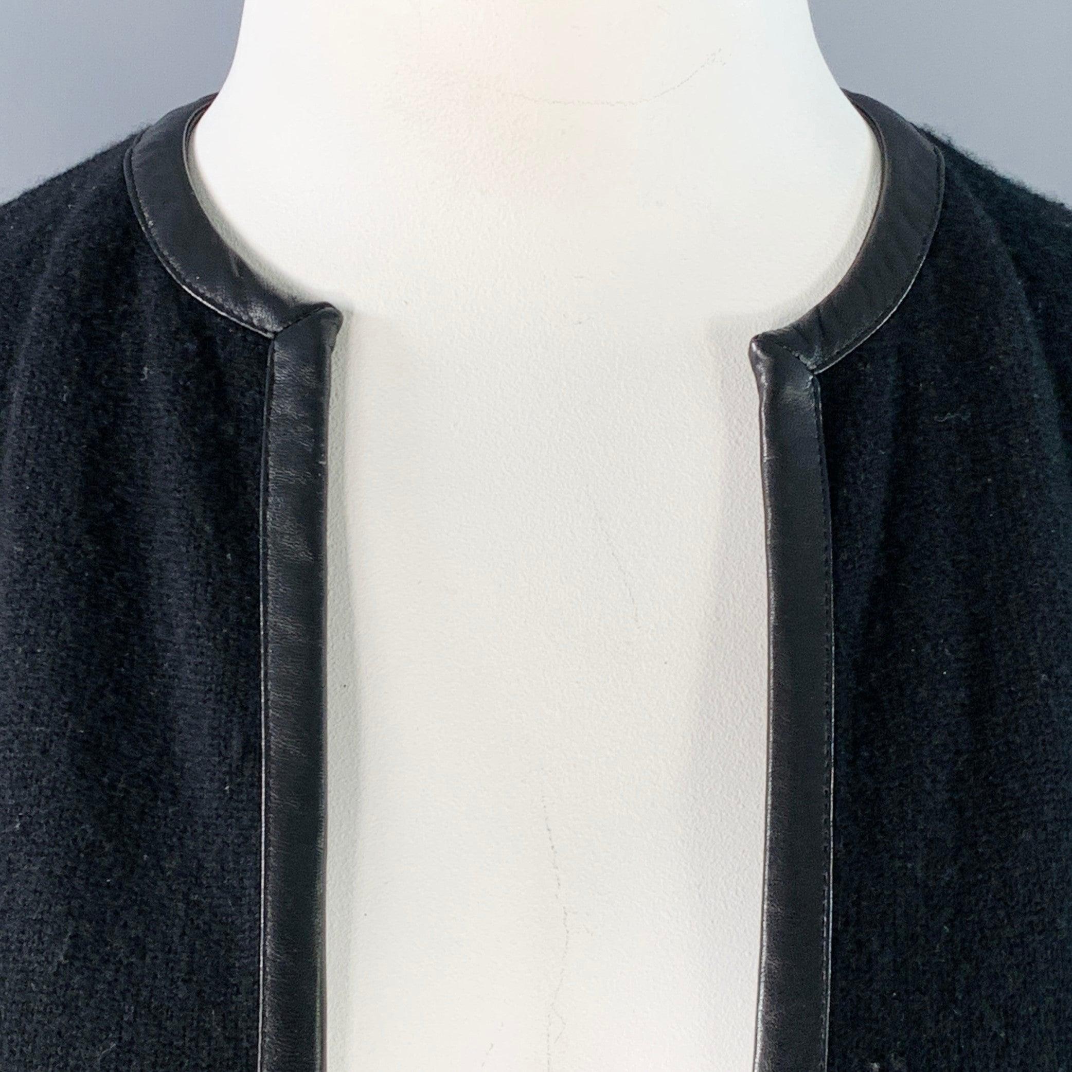 RALPH LAUREN BLACK LABEL cardigan
in a black cashmere fabric featuring a lambskin leather trim, two pockets, and open front. Good Pre-Owned Condition. Moderate pilling. 

Marked:   L 

Measurements: 
 
Shoulder: 15 inches Bust: 45 inches Sleeve: