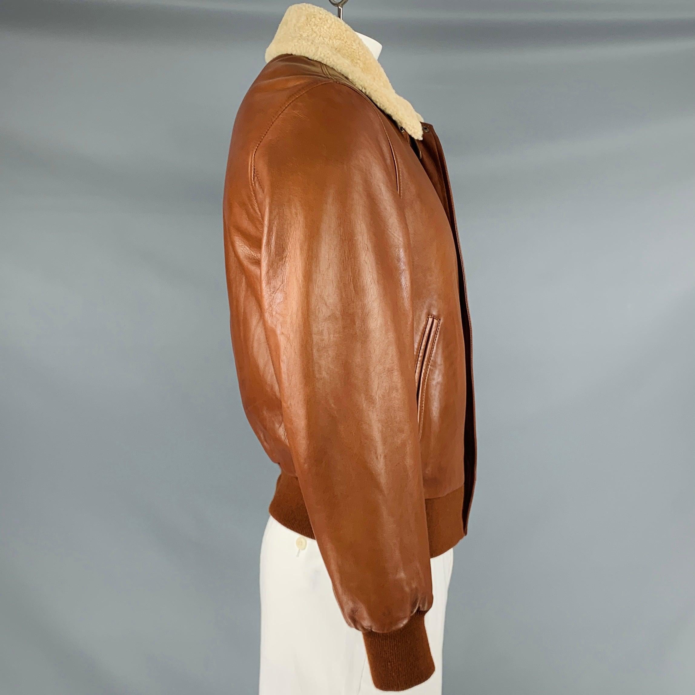 RALPH LAUREN PURPLE LABEL jacket
in a soft brown lambskin leather fabric featuring shearling collar, three pockets, and zip up closure. Made in Italy.Very Good Pre-Owned Condition. Minor signs of wear. 

Marked:   L 

Measurements: 
 
Shoulder: 17