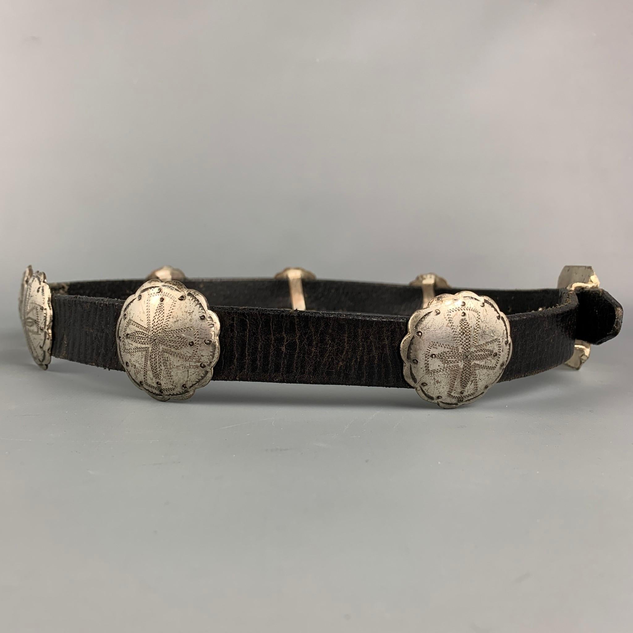 RALPH LAUREN belt comes in a black leather featuring silver tone concho accents and a artful concho buckle.

Good Pre-Owned Condition.
Marked: L

Length: 42 in.
Width: 1.25 in.
Fits: 32.5 in. - 36.5 in.
Buckle: 2.5 in. 