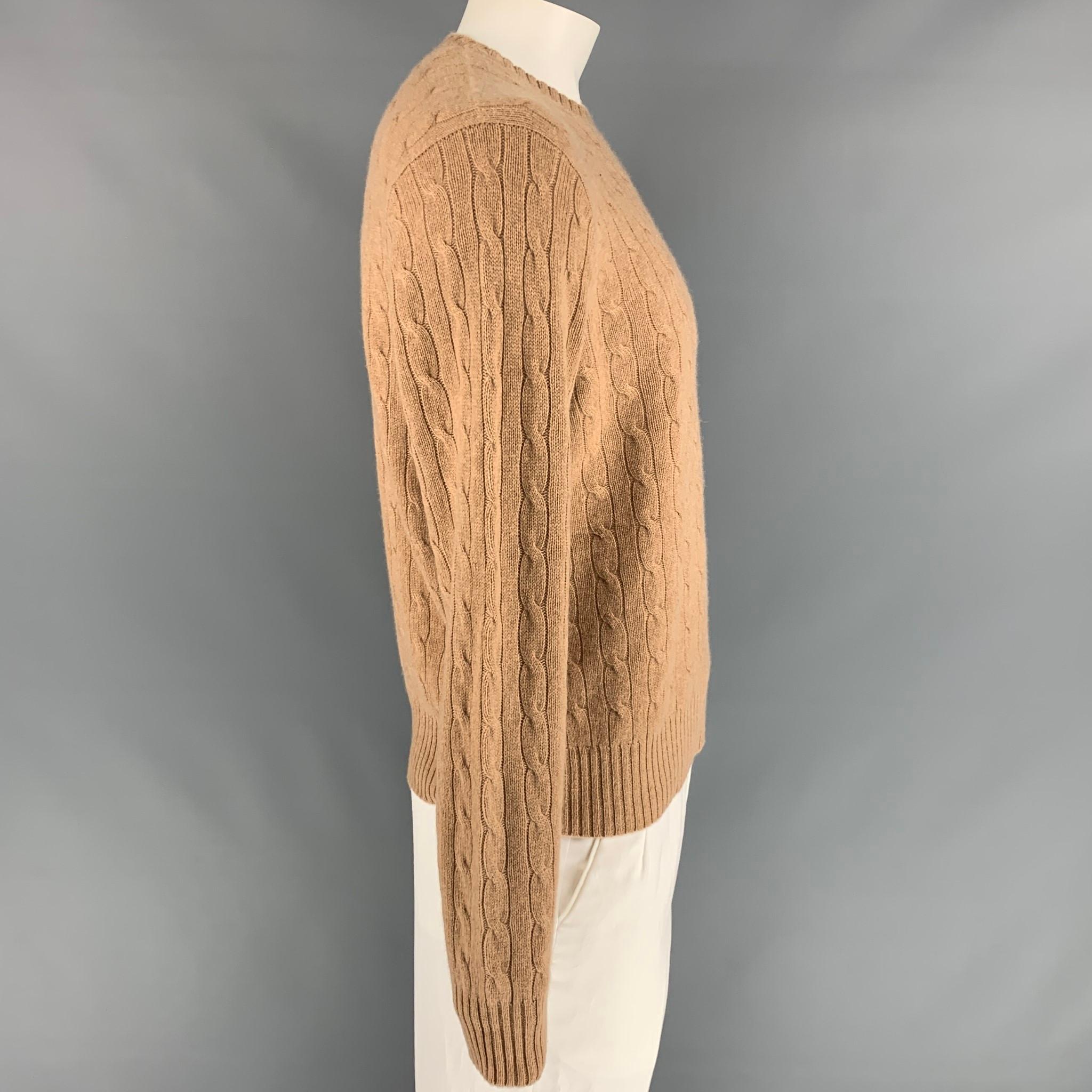 RALPH LAUREN sweater comes in a camel cable knit cashmere featuring a crew-neck. 

New With Tags. 
Marked: L

Measurements:

Shoulder: 20 in.
Chest: 46 in.
Sleeve: 29.5 in.
Length: 26 in. 