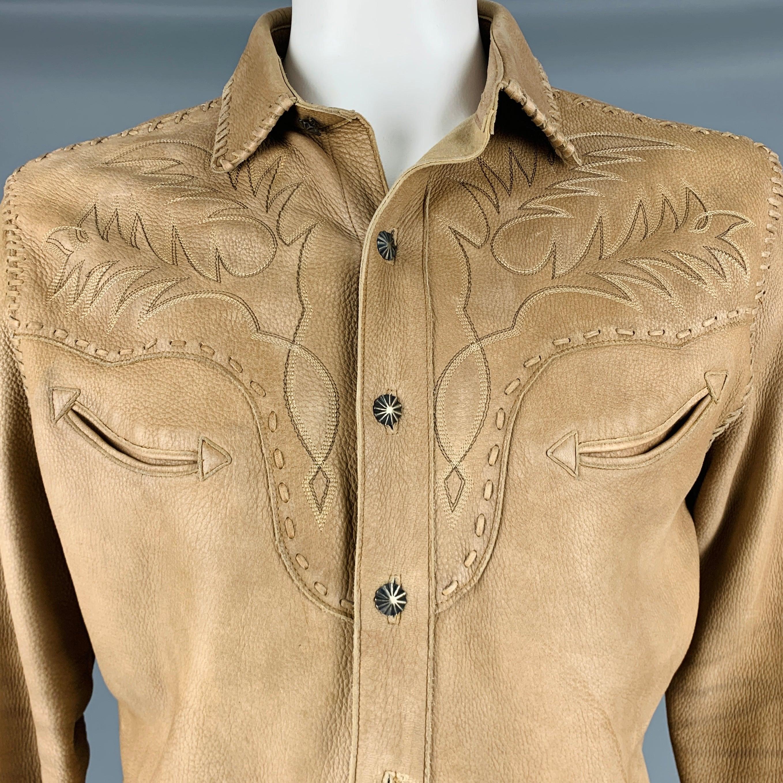 RALPH LAUREN long sleeve shirt
in a tan leather fabric featuring brown Western-style embroidery, brown contrast cuffs, two slit chest pockets, and button closure.Very Good Pre-Owned Condition. Moderate signs of wear. 

Marked:   L 

Measurements: 

