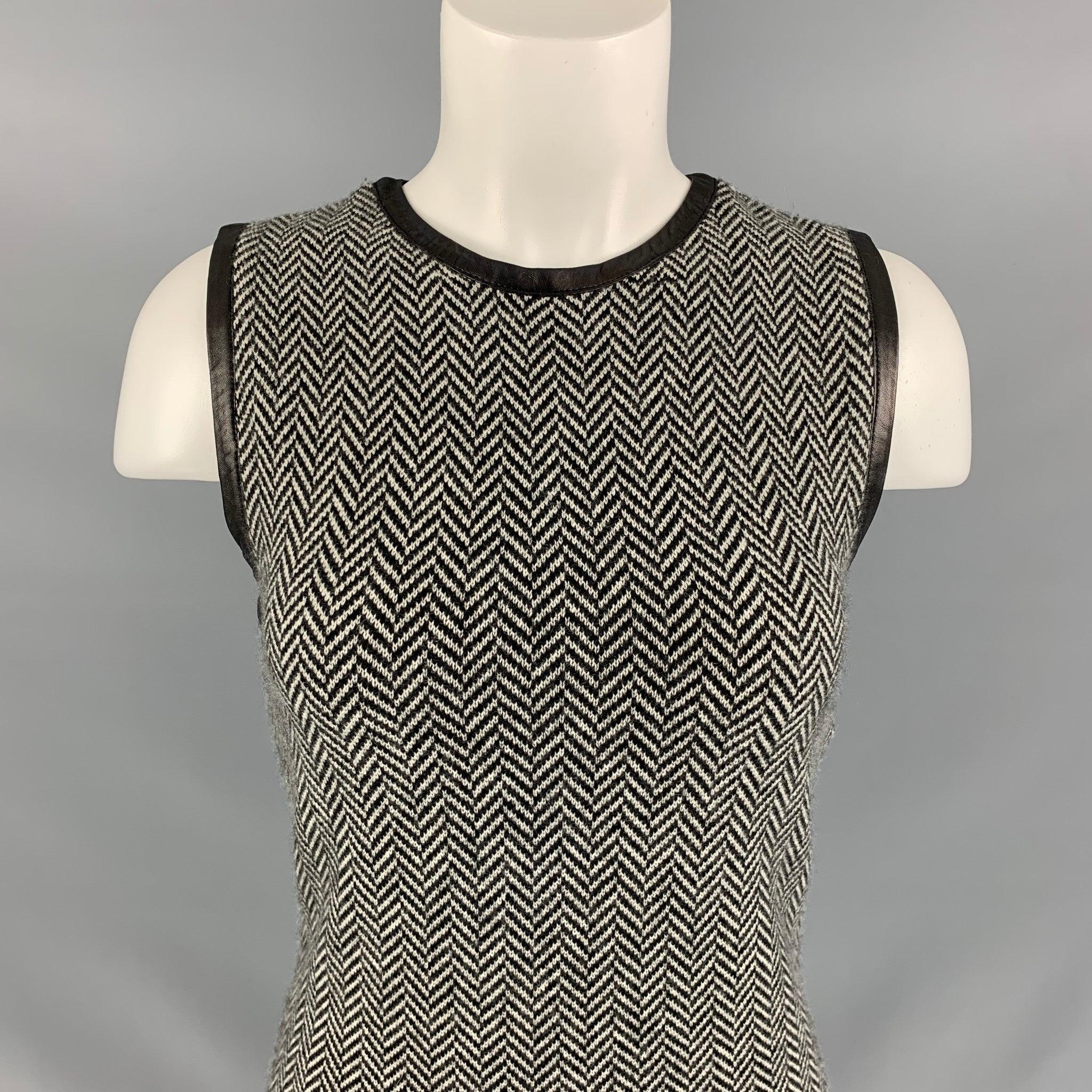 RALPH LAUREN Black Label below knee dress comes in a black and white cashmere, herringbone pattern and 1/4 invisible zipper closure at center back featuring a leather trim detail.
Very Good Pre-Owned Condition. 

Marked:   M 

Measurements: 
