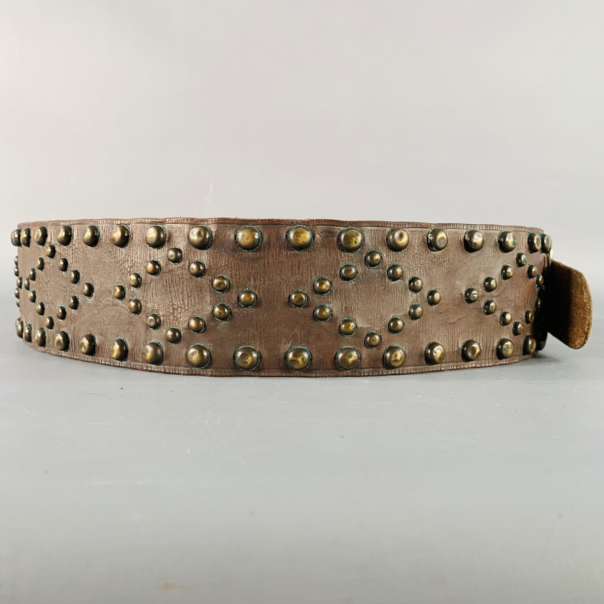 RALPH LAUREN Western belt
in a brown leather featuring a wide style, all over brass metal studded design, and buckle closure. Handmade in USA.Good Pre-Owned Condition. Moderate patina on studs and signs of wear on leather. As is. 

Marked:  