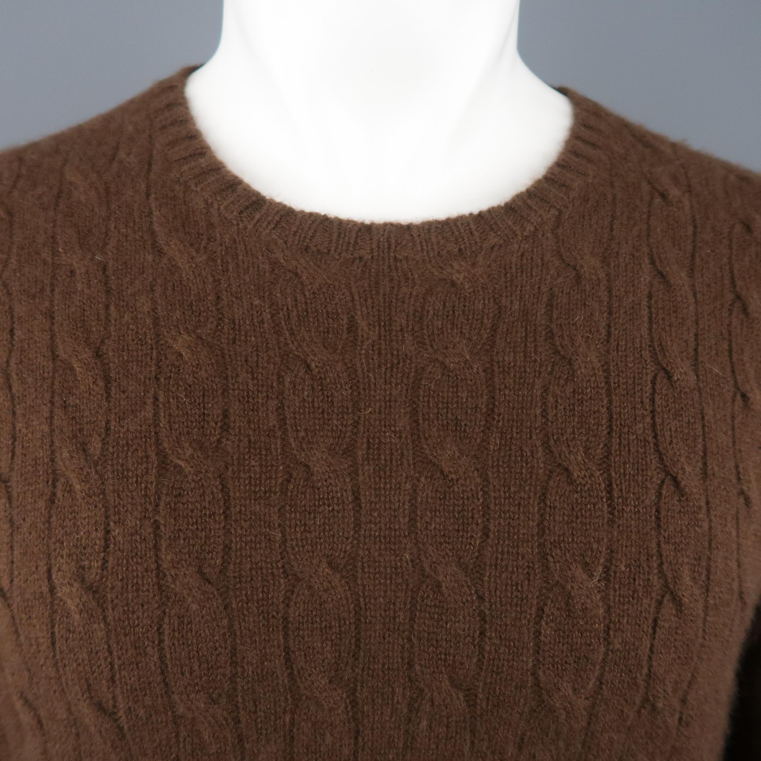 POLO RALPH LAUREN pullover sweater comes in brown cashmere cable knit with a ribbed crewneck and cuffs.
 
Excellent Pre-Owned Condition.
Marked: M
 
Measurements:
 
Shoulder: 18 in.
Chest: 46 in.
Sleeve: 27 in.
Length: 27 in.