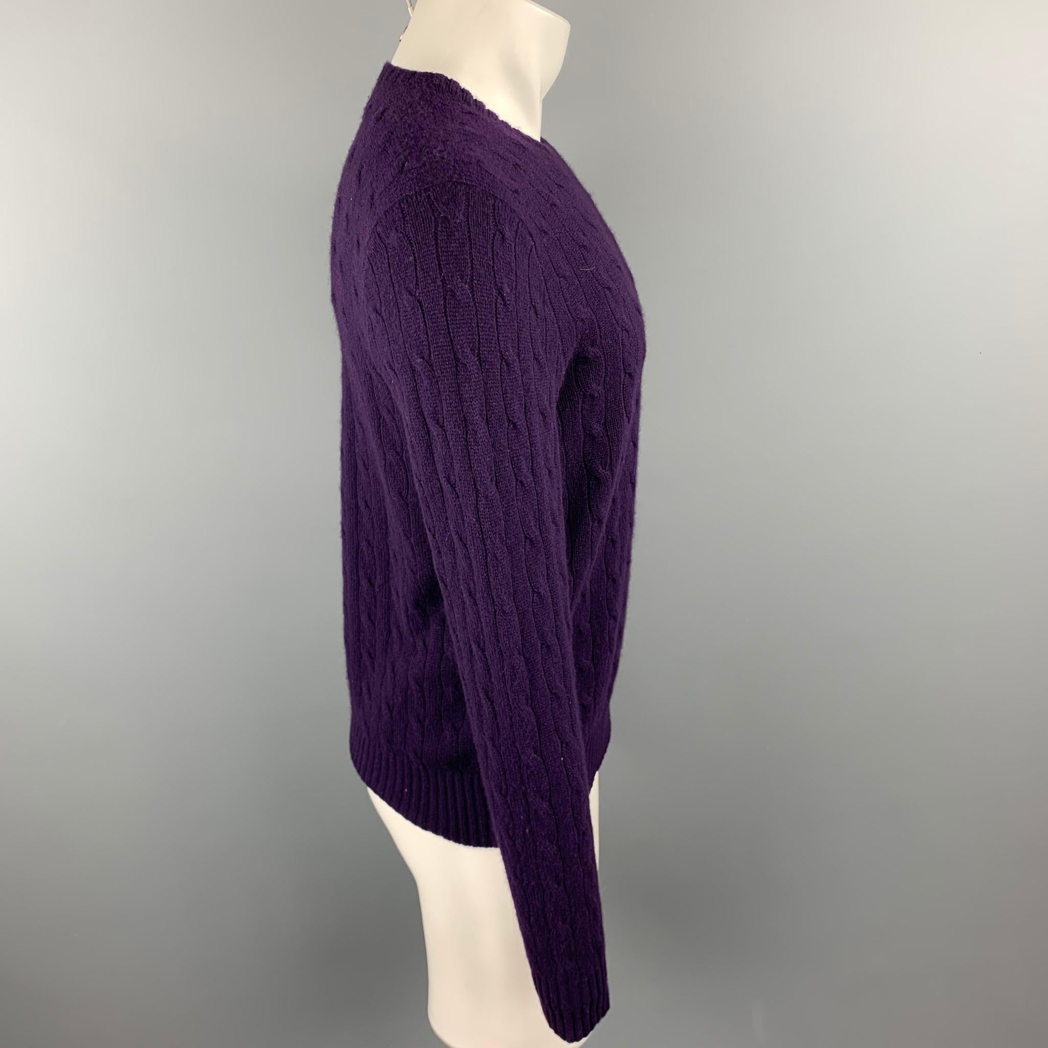 RALPH LAUREN sweater comes in a forest purple cable knit cashmere featuring a crew-neck.

Excellent Pre-Owned Condition.
Marked: M

Measurements:

Shoulder: 18 in.
Chest: 40 in.
Sleeve: 26.5 in.
Length: 25 in.  