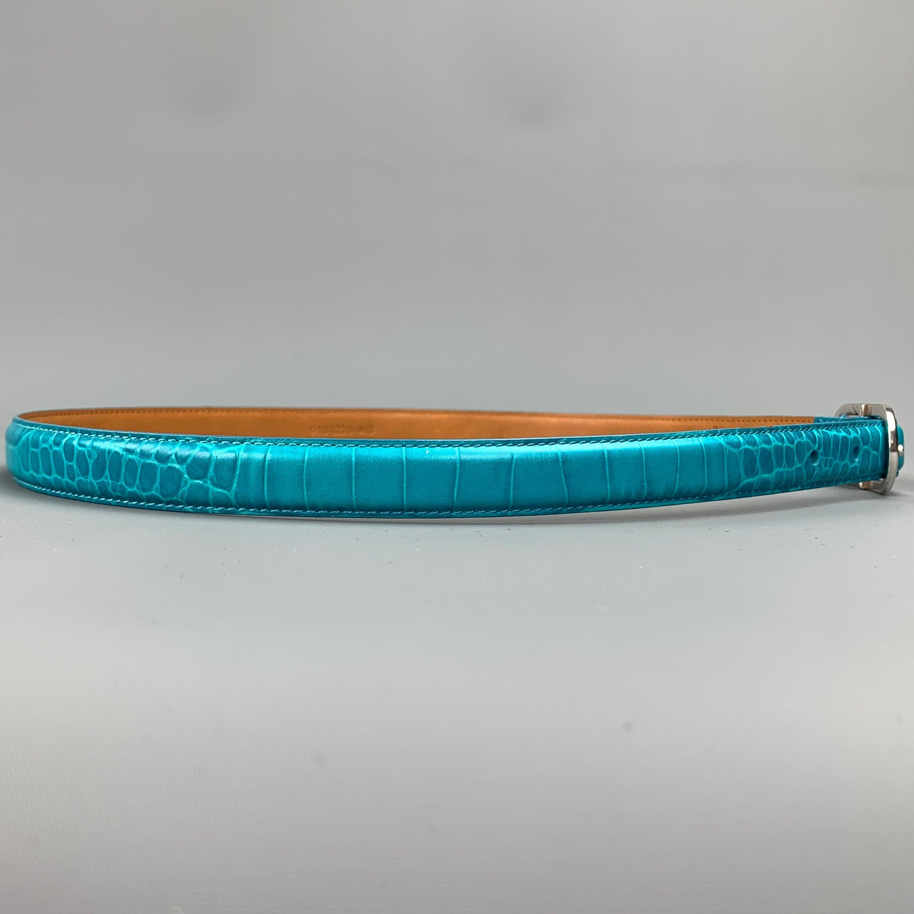 RALPH LAUREN skinny belt comes in a teal embossed leather featuring a silver tone buckle.Excellent
Pre-Owned Condition. 

Marked:   MLength: 37 inches 
Width: 0.5 inches 
Fits: 29 inches  - 33 inches 
Buckle: 2 inches 
  
  
 
Reference: