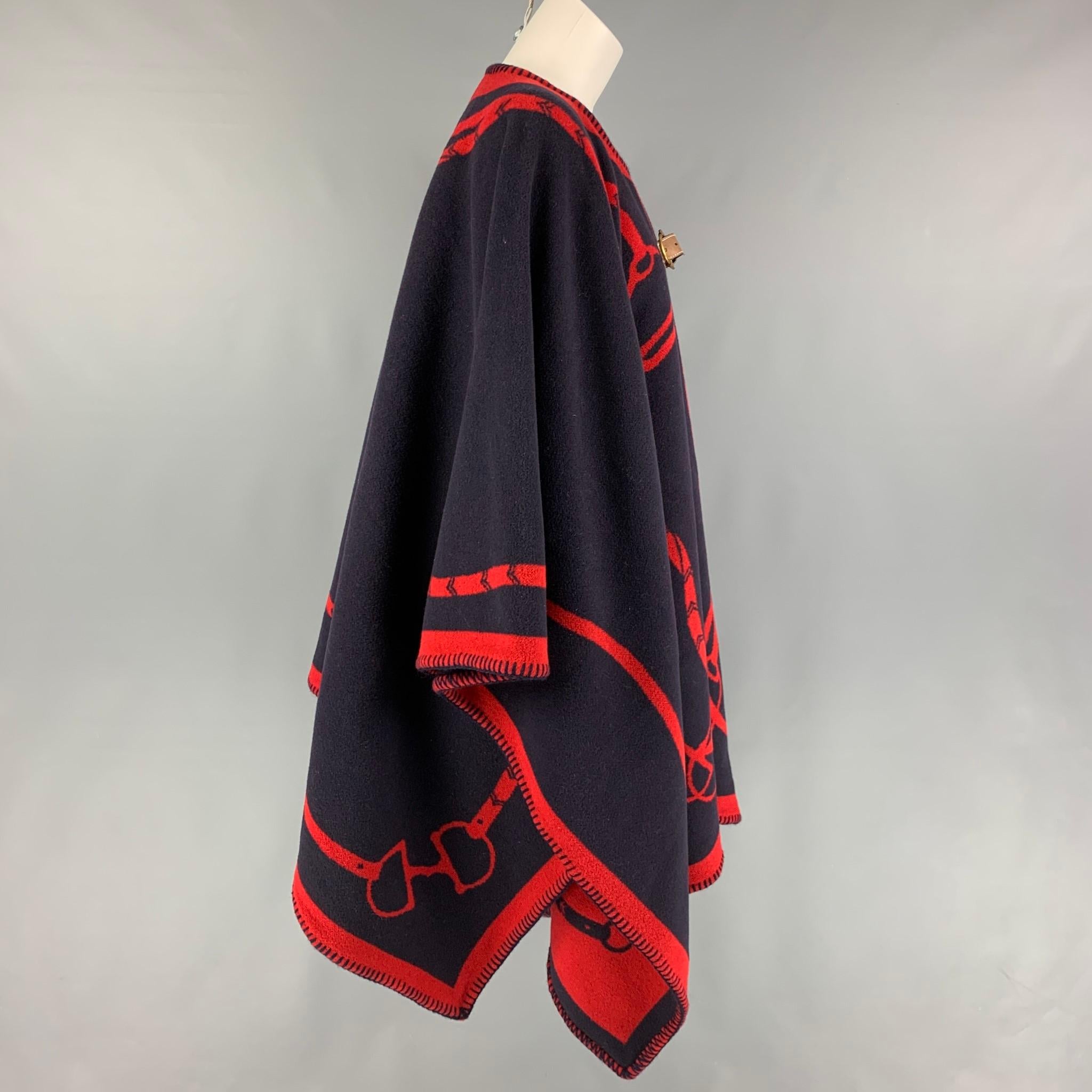 RALPH LAUREN cape comes in a navy & red wool featuring a equestrian print design and a leather strap closure. 

Very Good Pre-Owned Condition.
Marked: One Size

Measurements:

Length: 44 in. 