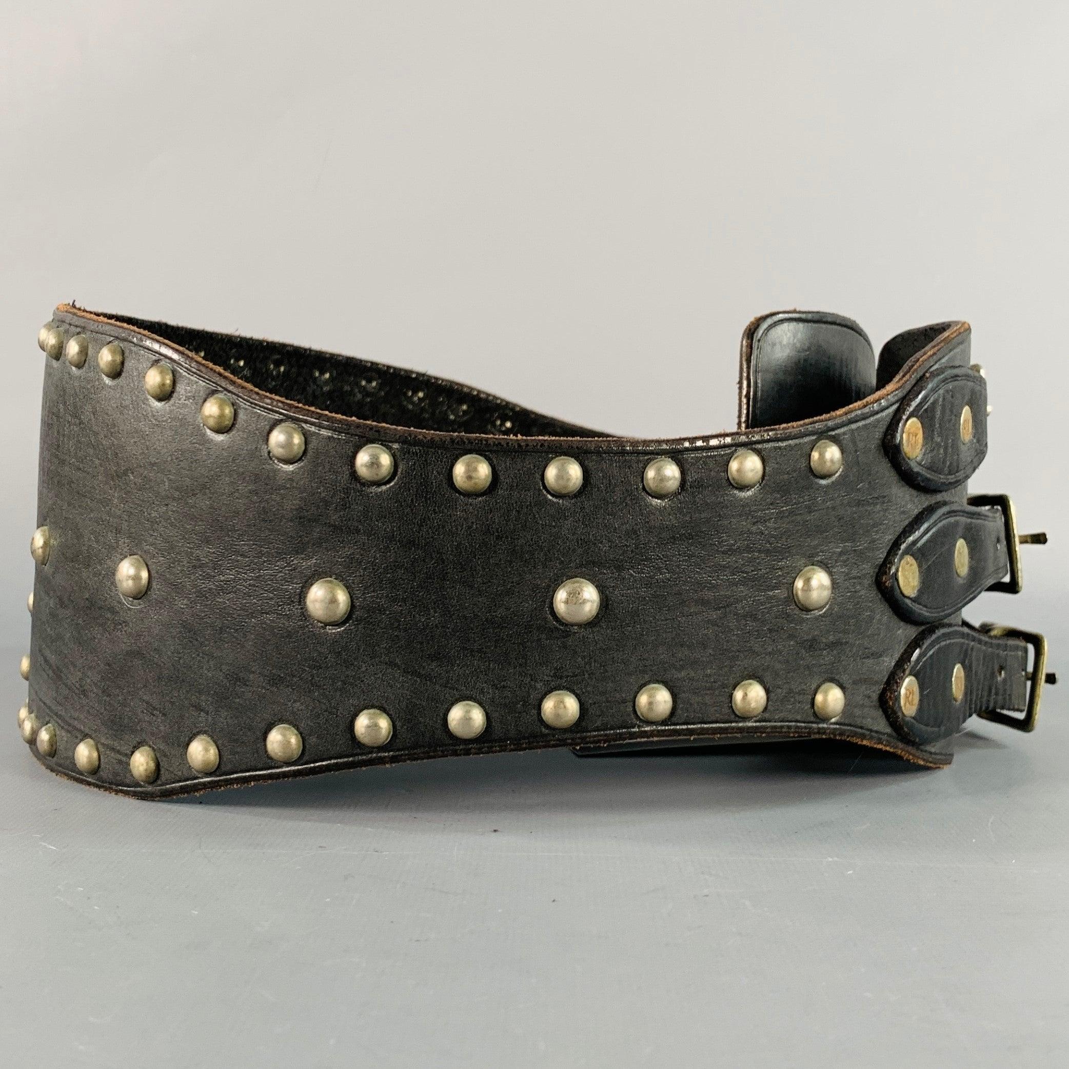 RALPH LAUREN belt in a black leather featuring a wide style with all over studs, three multicolor stone detail on back, and three silver tone metal buckle closures.
Made in USA.Excellent Pre-Owned Condition. 

Marked:   SLength: 35 inches Width: 4.5