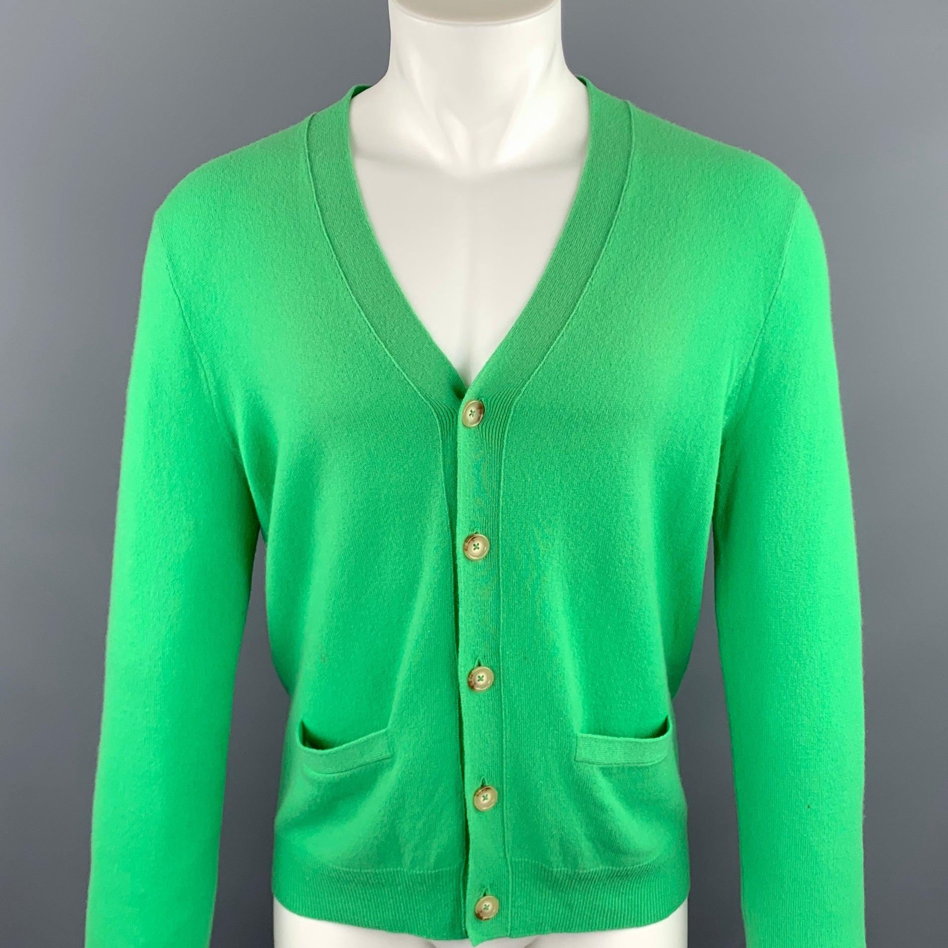 RALPH LAUREN cardigan green cashmere featuring slit pockets and a buttoned closure.New With Tags. 

Marked:   S 

Measurements: 
 
Shoulder: 16.5 inches  Chest: 38 inches  Sleeve: 26.5 inches  Length: 25.5 inches  
  
  
 
Reference: