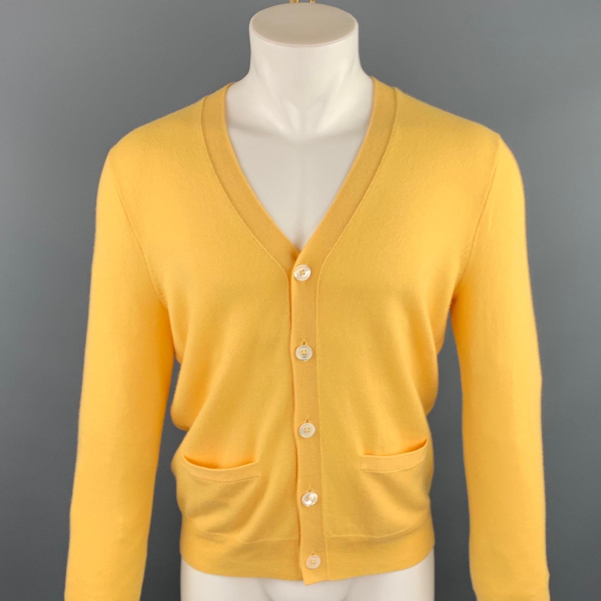 RALPH LAUREN cardigan yellow cashmere featuring slit pockets and a buttoned closure.

New With Tags.
Marked: S

Measurements:

Shoulder: 16.5 in. 
Chest: 38 in. 
Sleeve: 26.5 in. 
Length: 25.5 in. 