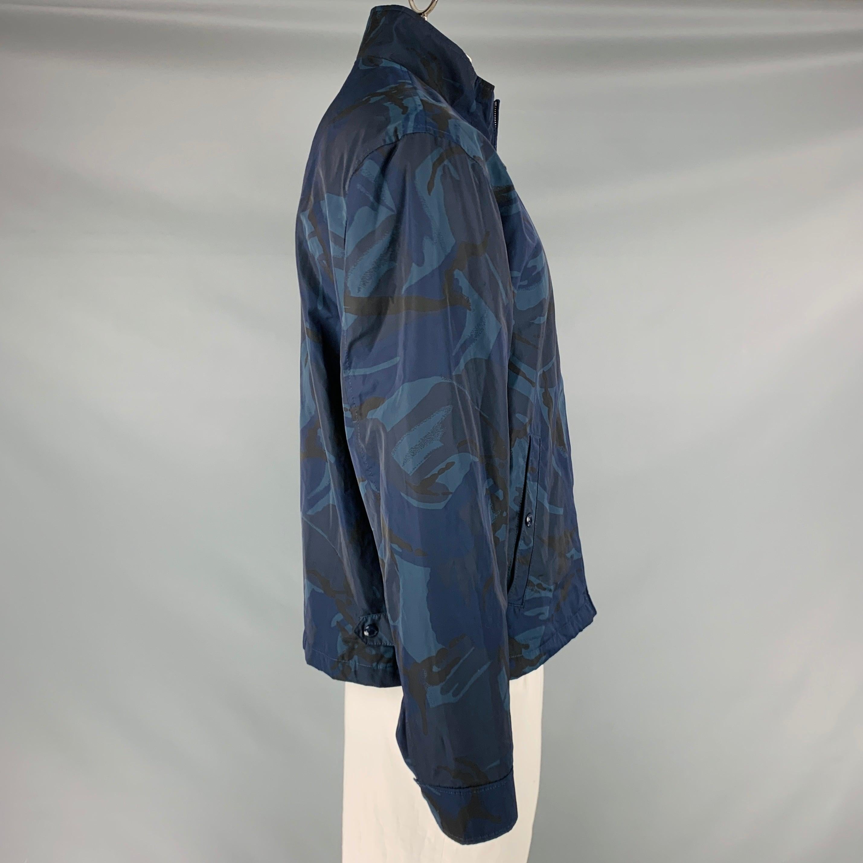 POLO by RALPH LAUREN jacket
in a navy and blue polyester fabric featuring camouflage pattern, two snap pockets, and zip up closure. Made in Italy.New with Tags. 

Marked:   XL 

Measurements: 
 
Shoulder: 19.5 inches Chest: 48 inches Sleeve: 26.5