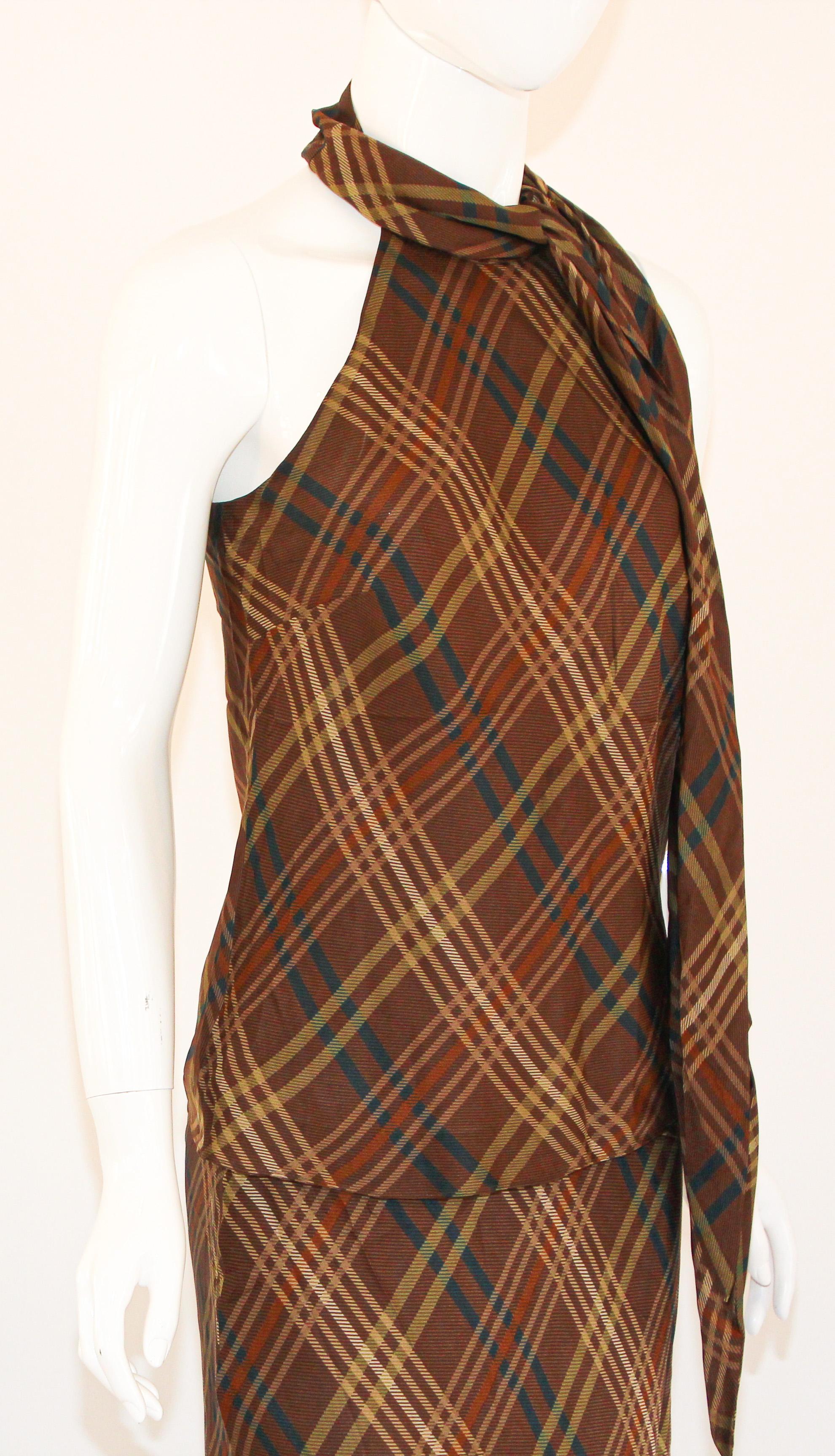 Ralph Lauren Silk Sleeveless Shirt and Maxi Skirt Set Brown Tartan.
With a tie-neck accent serves as the focal point of this glamorous sleeveless shirt and maxi skirt set.
Brown tartan plaid pattern, cut for an ankle-grazing silhouette.
Sheer silk