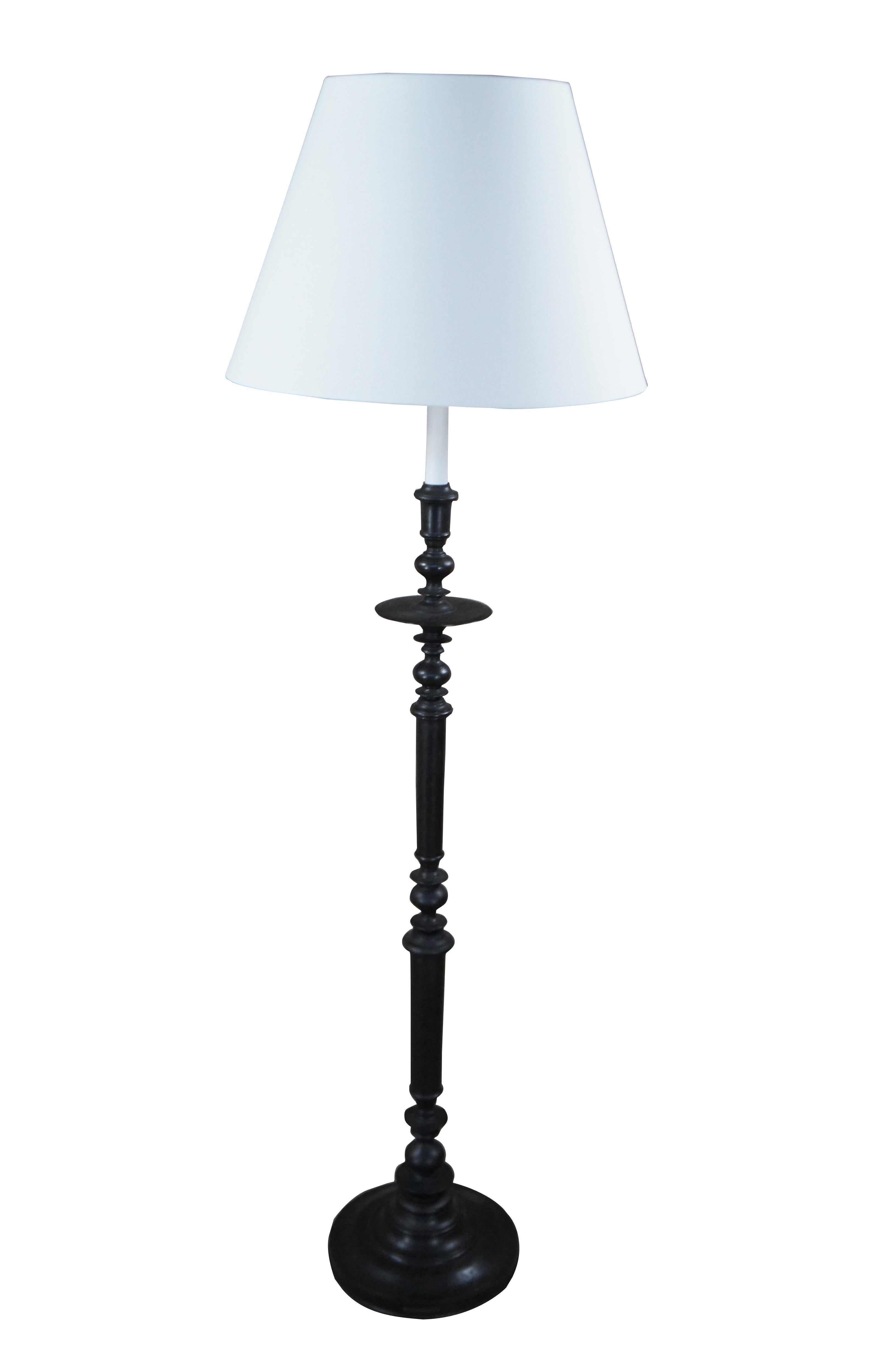 A beautiful old world Spanish Revival floor lamp by Ralph Lauren.  Features a rustic iron frame in the shape of an 18th century candlestand with a long candlestick and tapered shade.  Harp height is adjustable.

Dimensions:
63