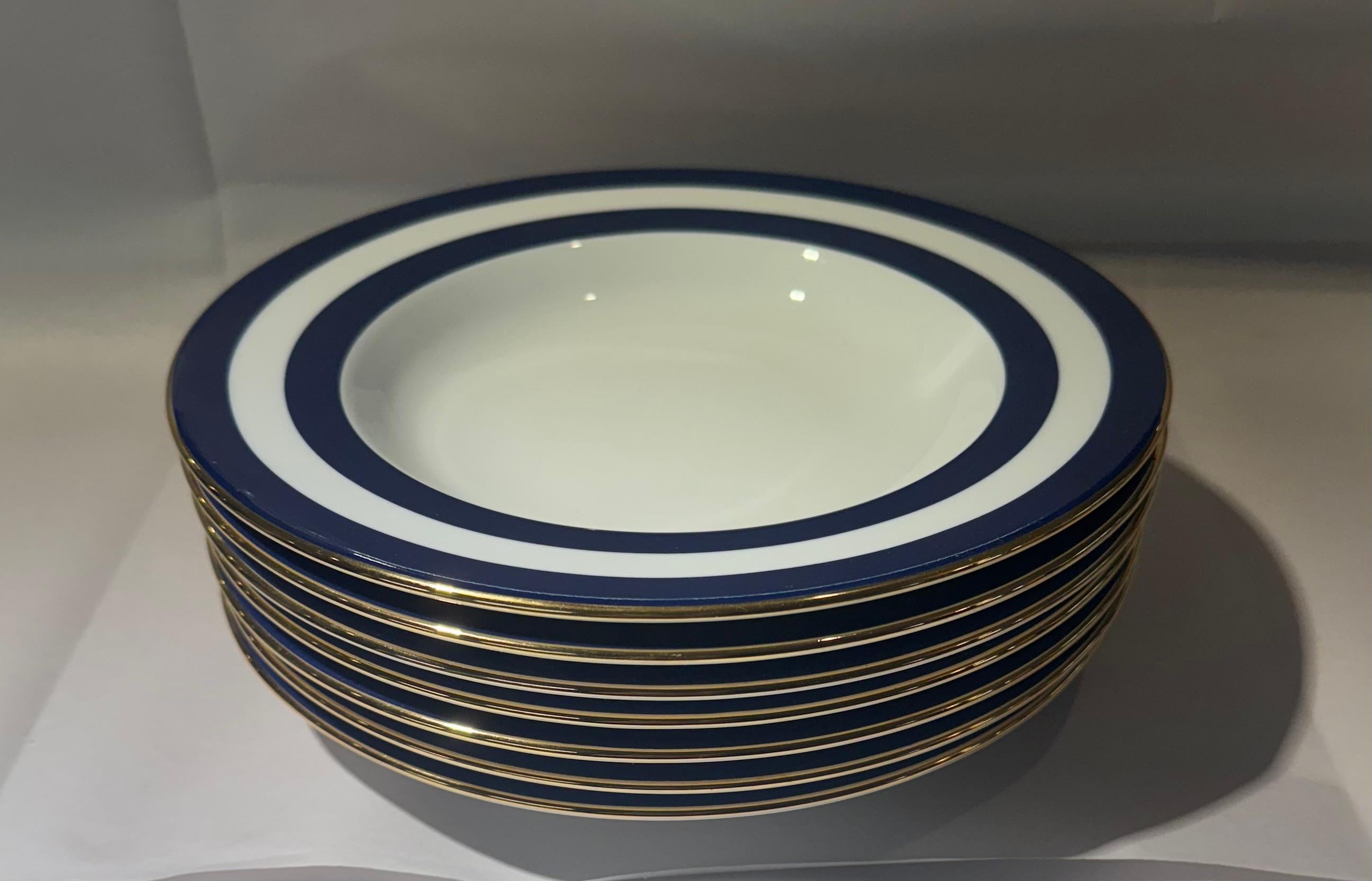 Set of six (6) rim soup / pasta bowls in the Spectator Cadet (blue) pattern by Ralph Lauren Home.

Includes the following:
6 bowls

Size: 9-1/8 inches W


Details:
Made of white ceramic with blue wide stripe border with gold trim.
Made in Portugal,