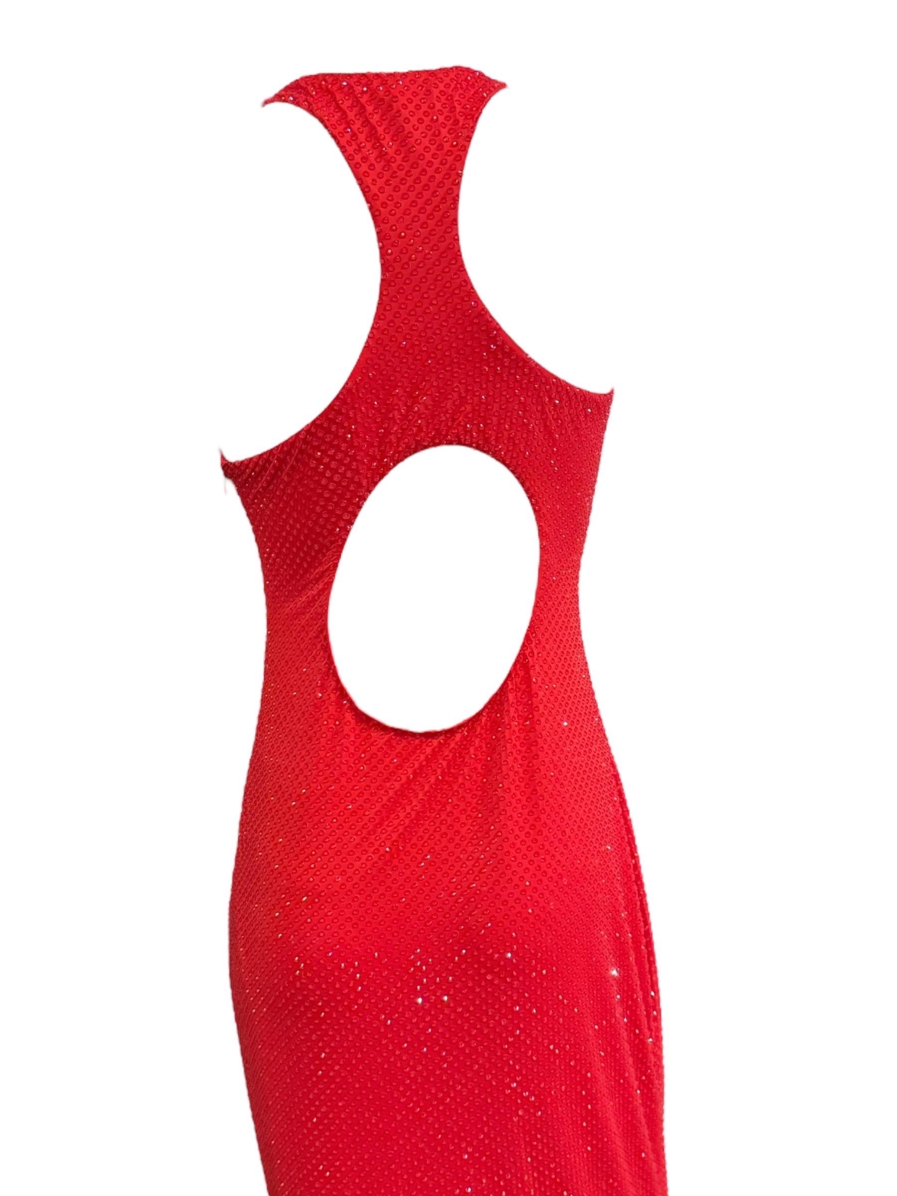 A stunning revival of Ralph Lauren’s iconic Spring 1996 silhouette, this red embellished gown was reimagined for the Spring 2023 Ready-to-Wear collection and debuted as Look 57 on the runway. Sleek and striking, the floor-length column dress is