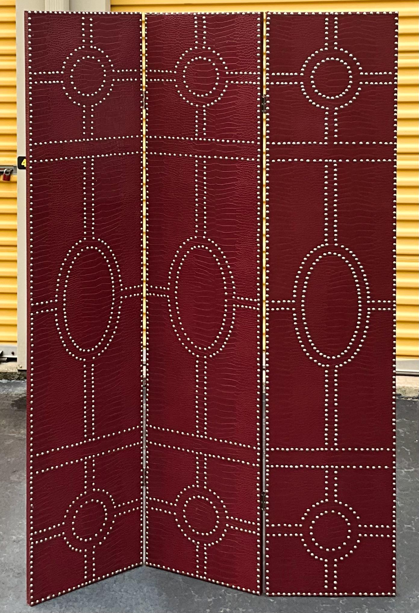 This is a handsome deep red folding screen with chrome nailheads. It has timeless appeal and would work well from wall to floor. It is unmarked and in very good condition.

My shipping is for the Continental US only, and it can run two to five