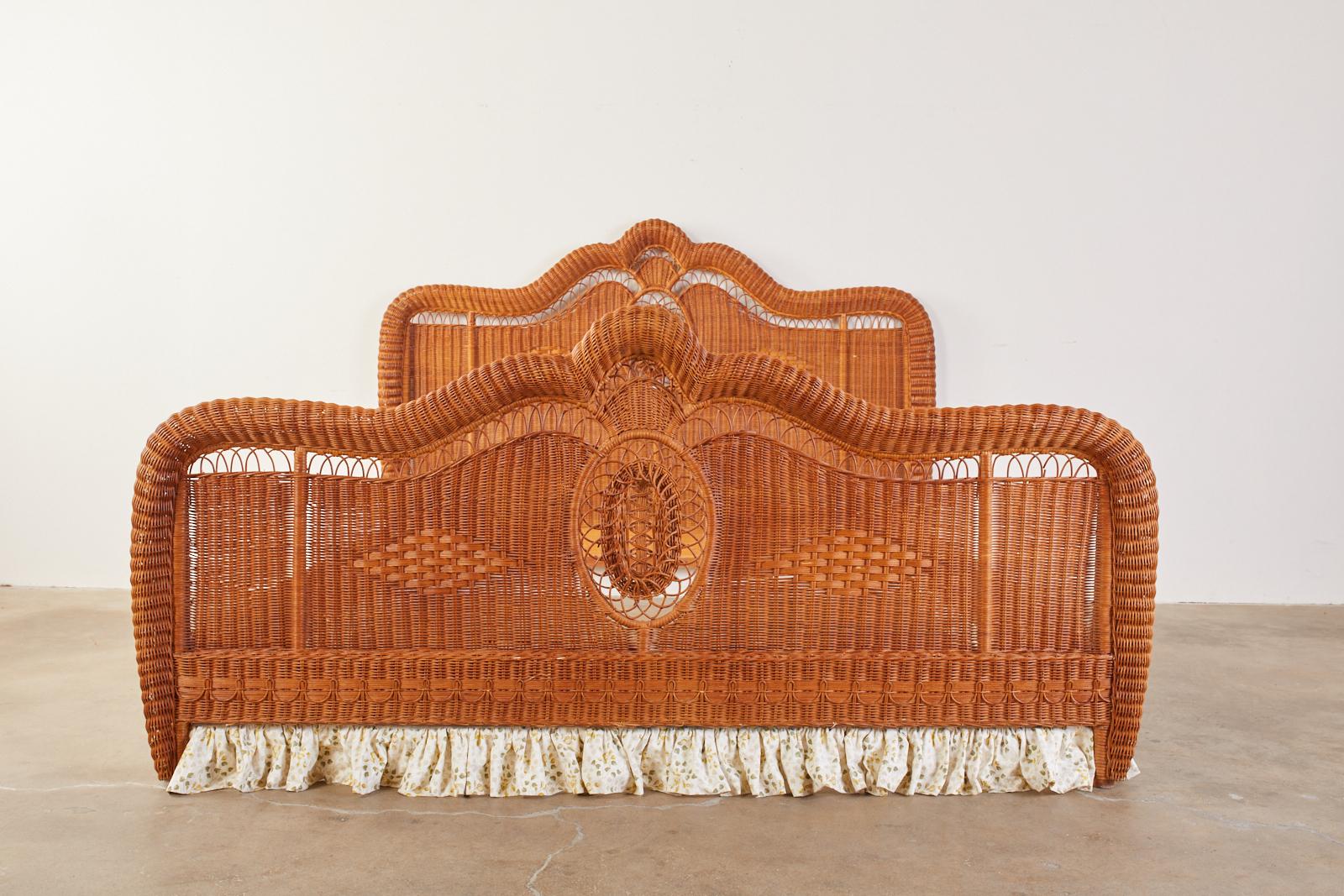 Fantastic 20th century Bohemian wicker bed made in the style of the later reproduction beds by Ralph Lauren. Features gracefully curved headboard and footboard centered with open fretwork oval designs. The rails and footboard have decorative dust