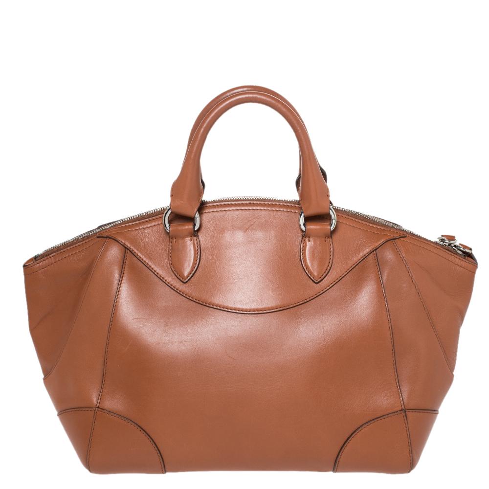 This satchel from Ralph Lauren is undoubtedly your next best buy! The bag in tan features a striking metal detail on the front, dual handles and a canvas-lined interior to hold your essentials. Team this up with casual or formal attires.

Includes:
