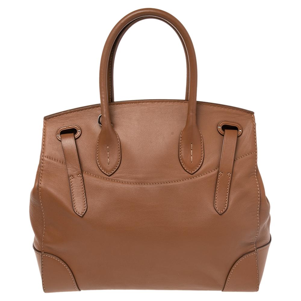 This Ralph Lauren Ricky bag is simply breathtaking. Meticulously crafted from leather, the bag delights not only with its appeal but its structure as well. It is held by two top handles, detailed with silver-tone hardware, and equipped with a
