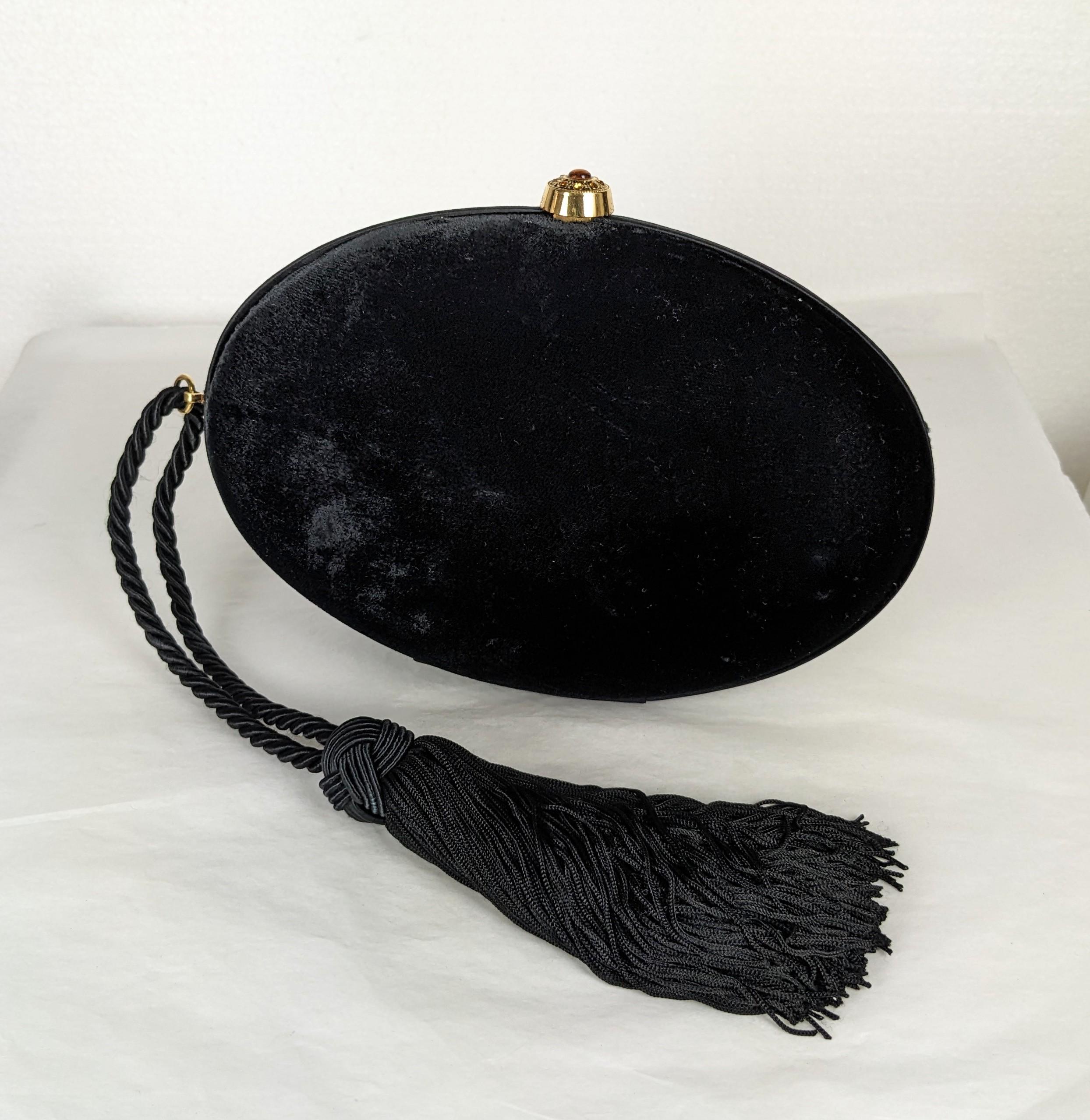 Elegant Ralph Lauren Velvet Minaudiere with silk tassel cord. Egg shaped with soutache trimmed interior and citrine paste set clasp. Silk cord and tassel handle. 2000's Italy. 8