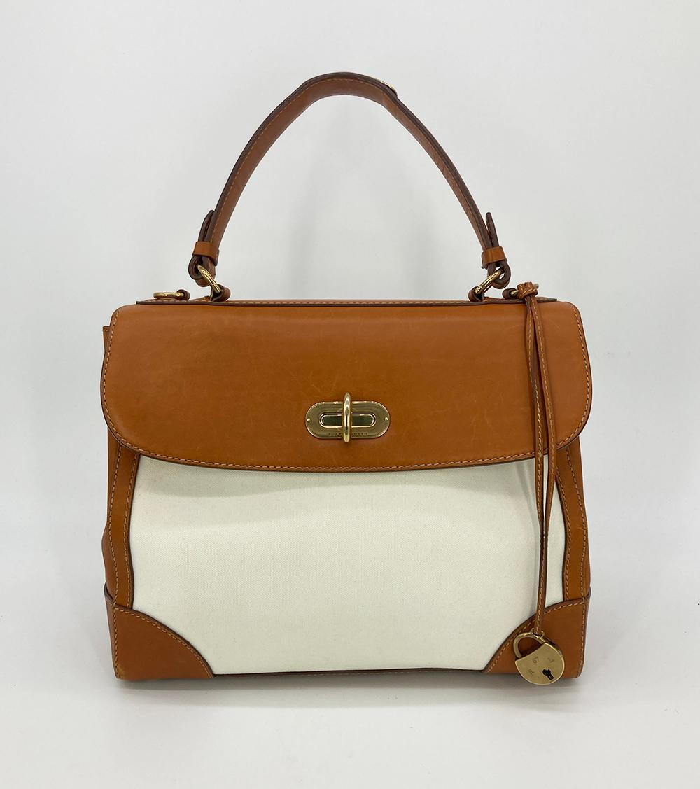 Ralph Lauren Vintage Cream Canvas Tan Leather Rickey Bag in fair condition. Cream canvas body surrounded by tan leather edges, corners, top flap   and handle. Removable adjustable matching tan leather shoulder strap included. Front top twist lock