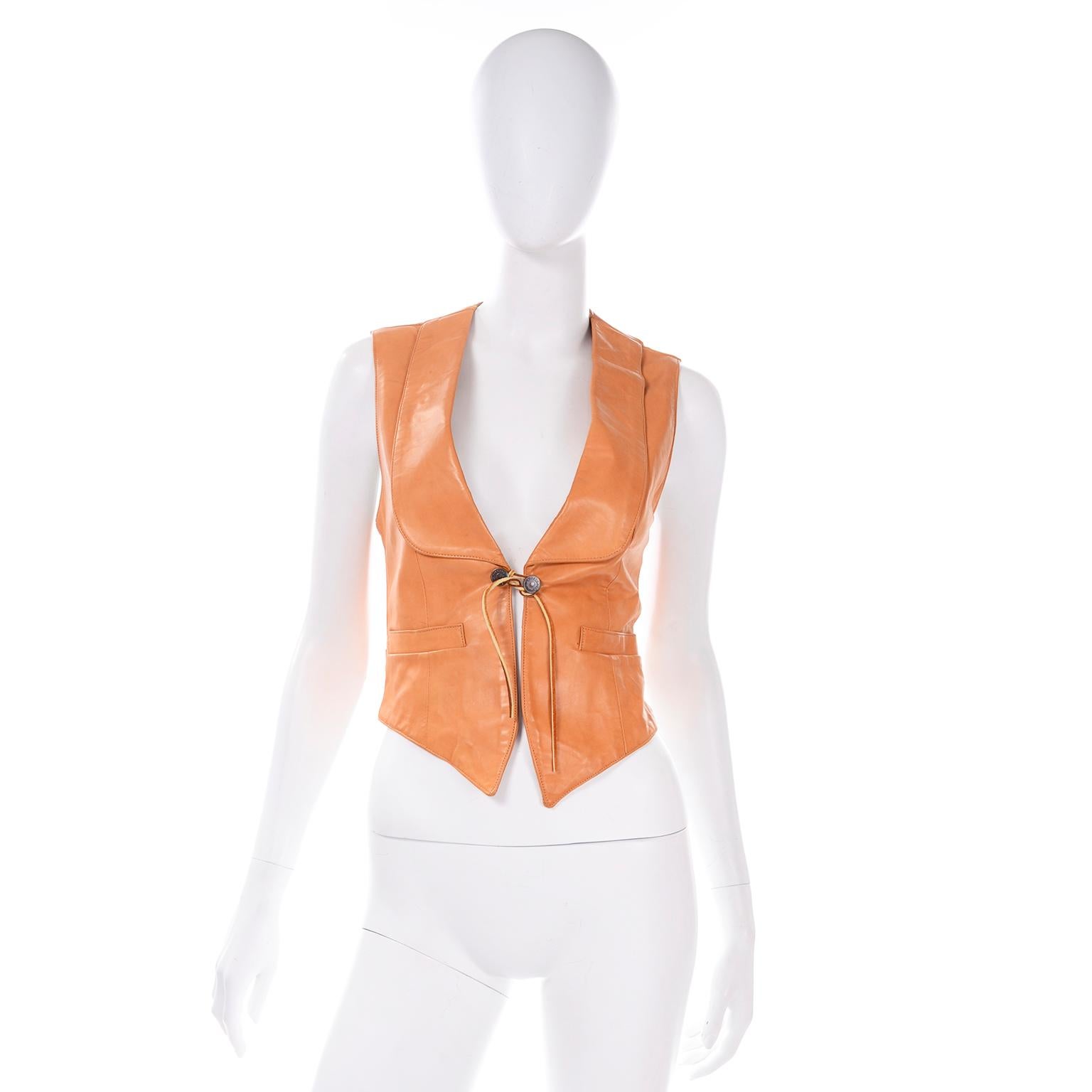 We are so in love with this amazing vintage lambskin leather vest from Ralph Lauren's western wear collection. This vest is made of a terracotta brown genuine lambskin and fully lined. There are two front pockets, a notch collar,  two metal branded