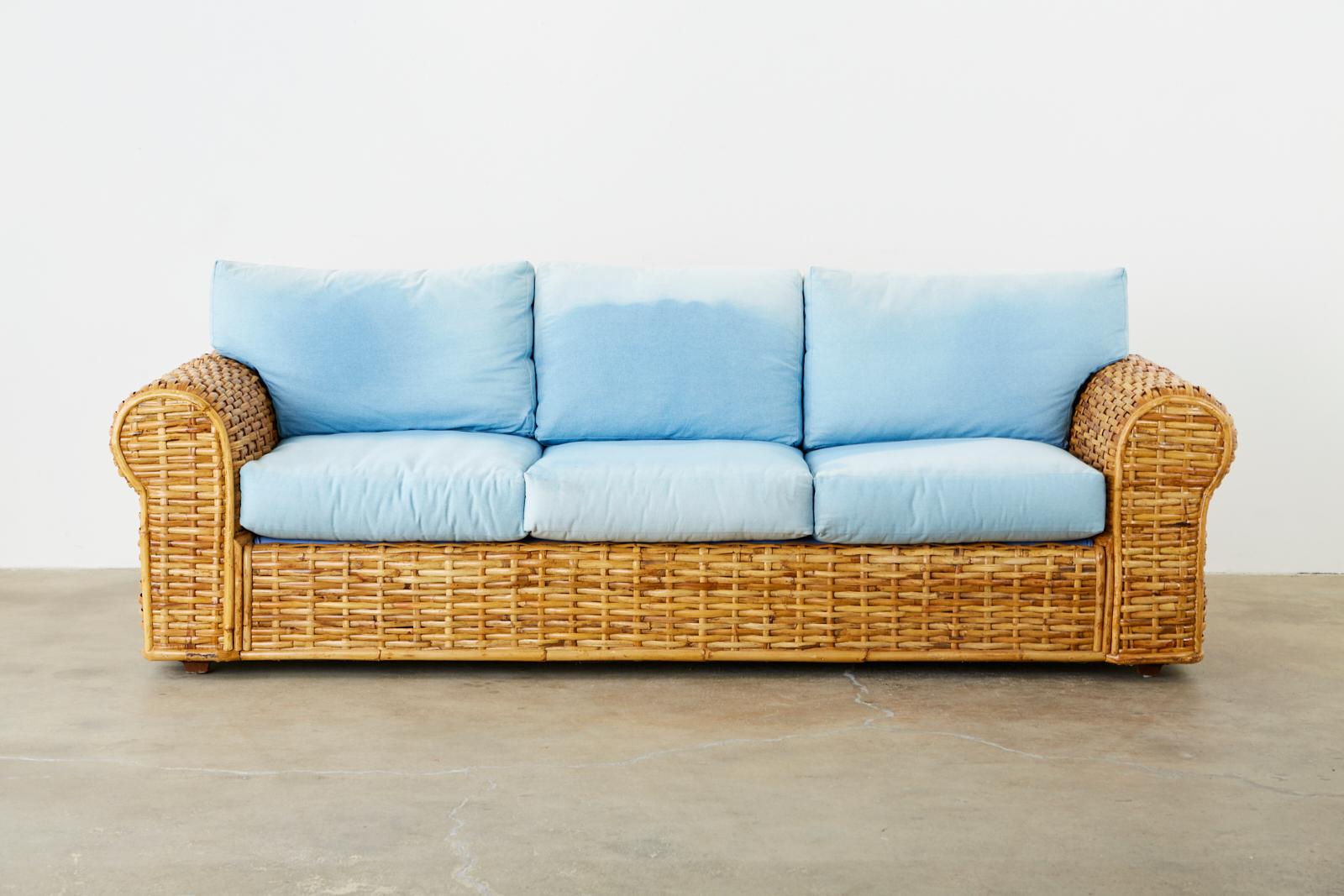Grand sofa by Ralph Lauren Polo collection constructed from woven bamboo rattan reeds. Features a faded blue soft denim type cotton upholstery that has lovely age and ombre color. Made in the organic modern style late 20th century. Beautiful profile