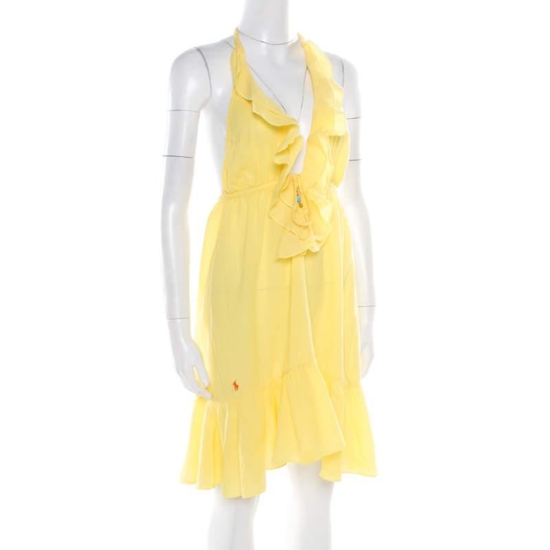 This Ralph Lauren sundress has everything that you can possibly have in a designer piece. Kick-start your day on a happy note with this gorgeous yellow dress that is styled with a plunging neckline held by halter straps and embellishments at the