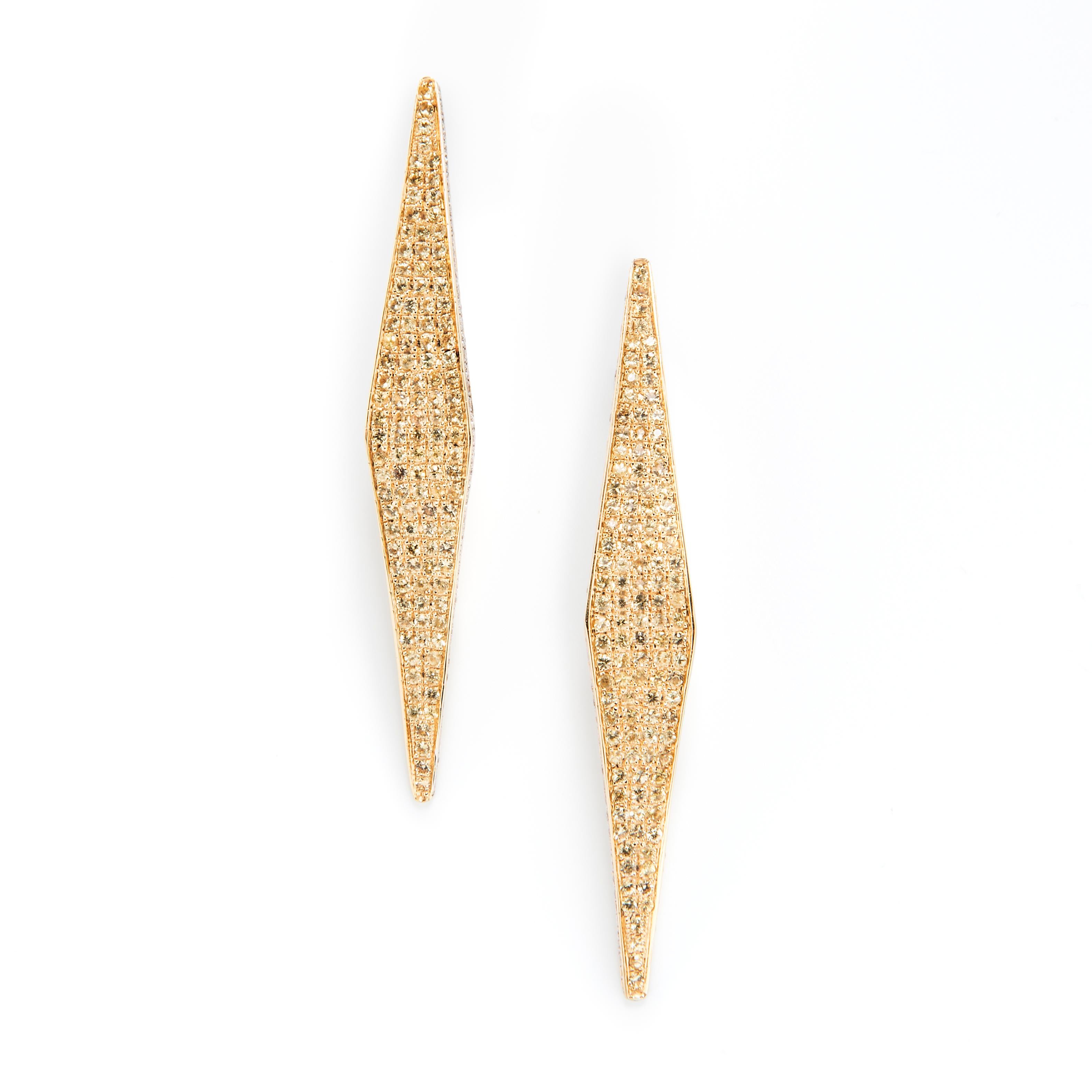 Resplendent in shades of yellow, these dramatic geometric earrings are inspired by the glass towers of mid-century modern architecture. 

18k Yellow Gold, diamonds
Yellow sapphire pave with diamond border
Yellow sapphire TCW is 2.30 and Diamond TCW