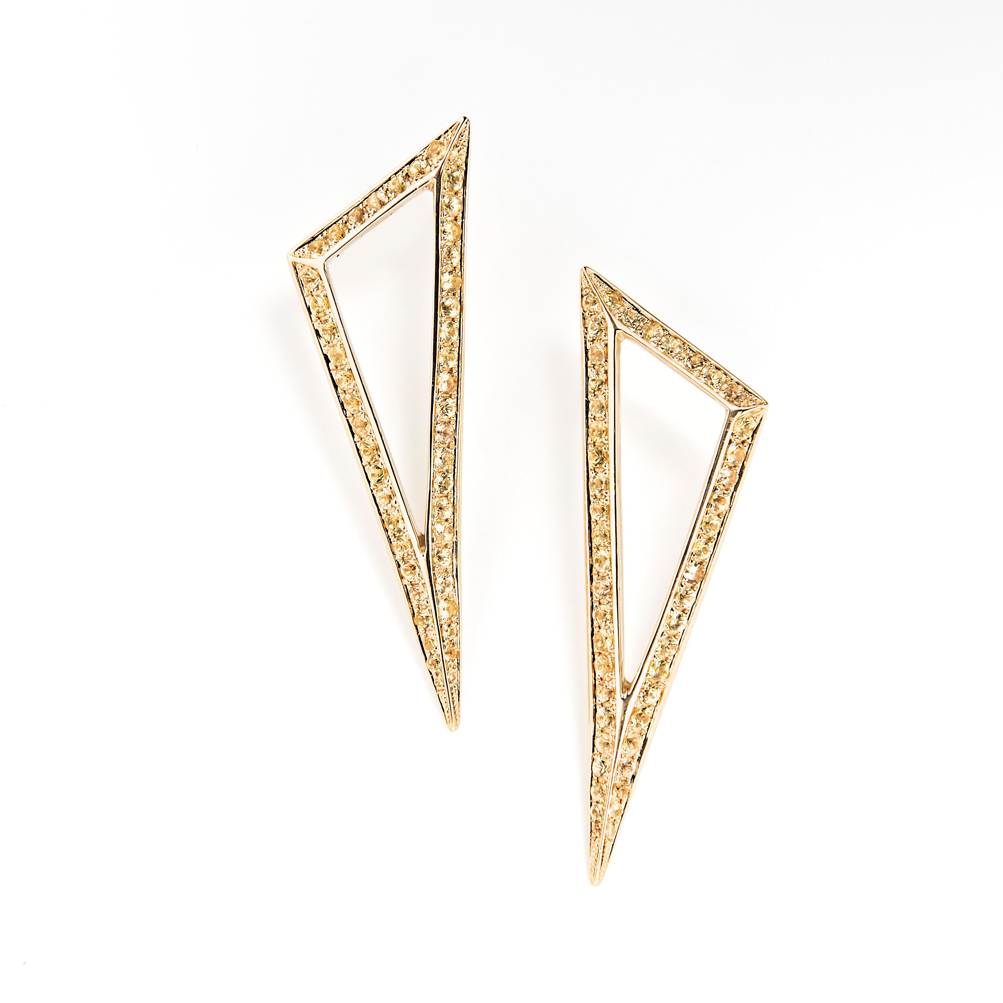 Keep your look on point with these triangle form earrings. The refined shape sparkles with dazzling yellow sapphires.

18k White Gold
Yellow sapphire TCW 2.60
Friction post and back closure 
Length is 2 inches and width is 0.65 inches