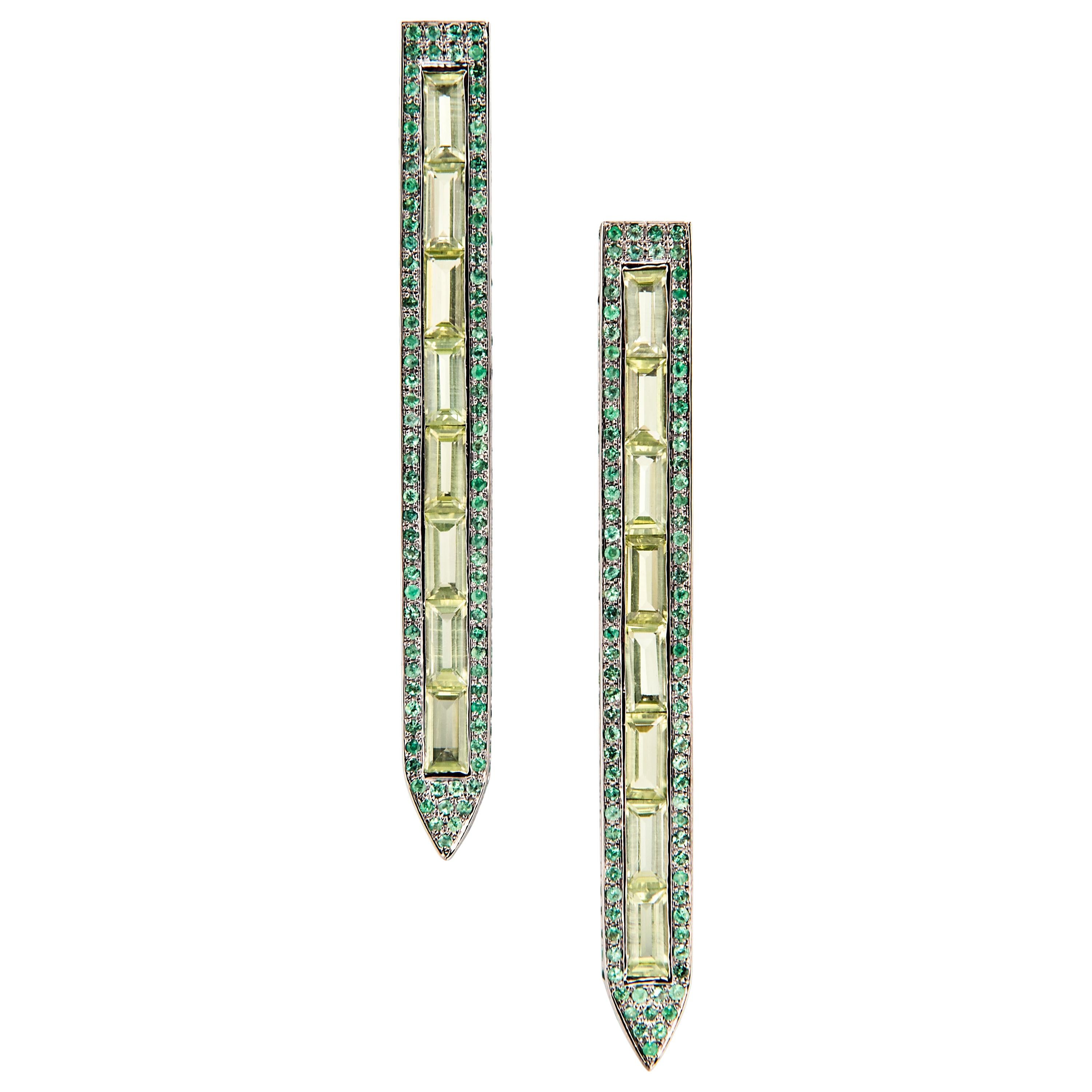 Inspired by stained glass cathedral windows, these elongated and vibrantly colored earrings are an elegant addition to any jewelry wardrobe.

18K White Gold
Emerald TCW is 2.25
Peridots
Friction post and back closure
Length is 2.25 inches and width