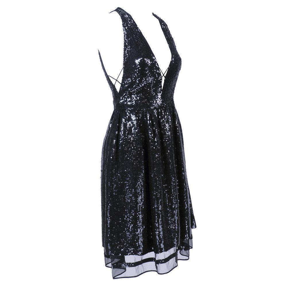 Sweet, but sexy black cocktail dress completely covered in sequins with lace-up detail at sides. Deep-v neck, cut with gathered skirt with sheer silk underlay. Very light and swingy. Excellent condition.

Additional information:
Dimensions: Bust: 