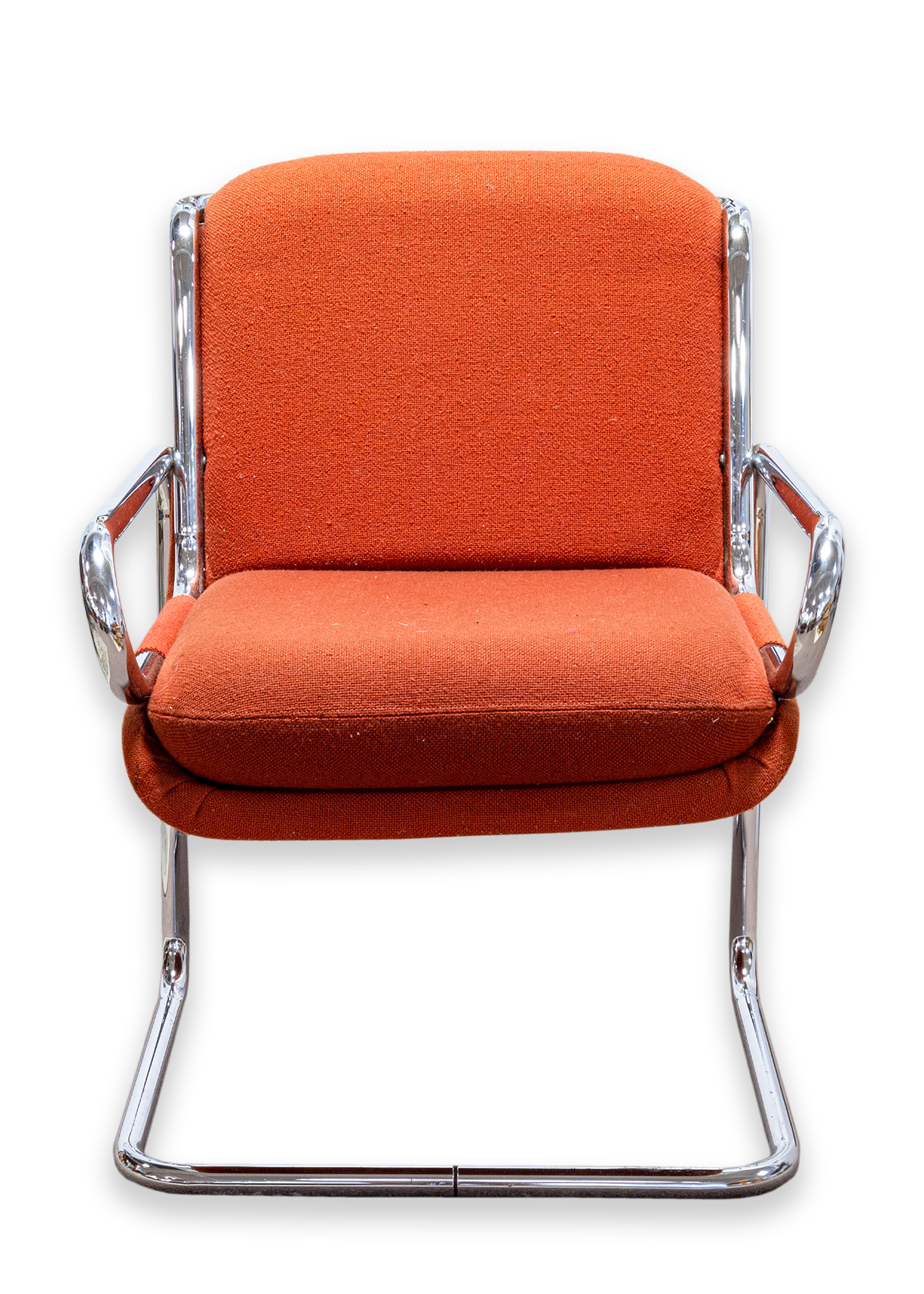 A rare chair prototype – the “Rye Chair” by Ralph Rye for Dunbar / Dux Furniture. Circa 1970. The frame is constructed with tubular stainless steel. This version has the cushion seat, upholstered in orange Knoll fabric, original to the prototype.