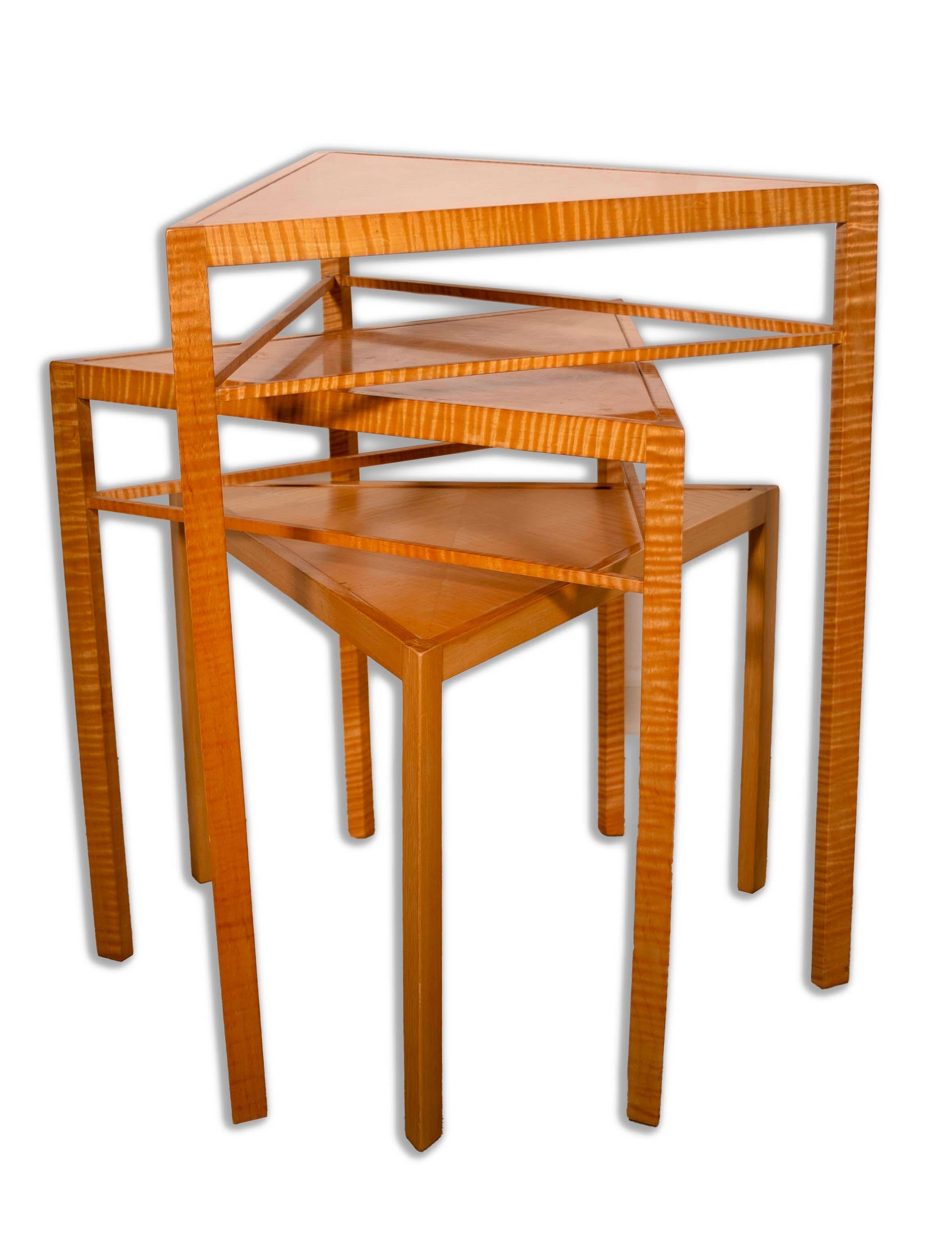 A handmade set of three postmodern nesting tables from the studio of furniture designer Ralph Rye – referred to as the “Kite Tables” design. Signed on underside and dated 2005. Triangular geometric forms made in curly maple wood. The top two-tier