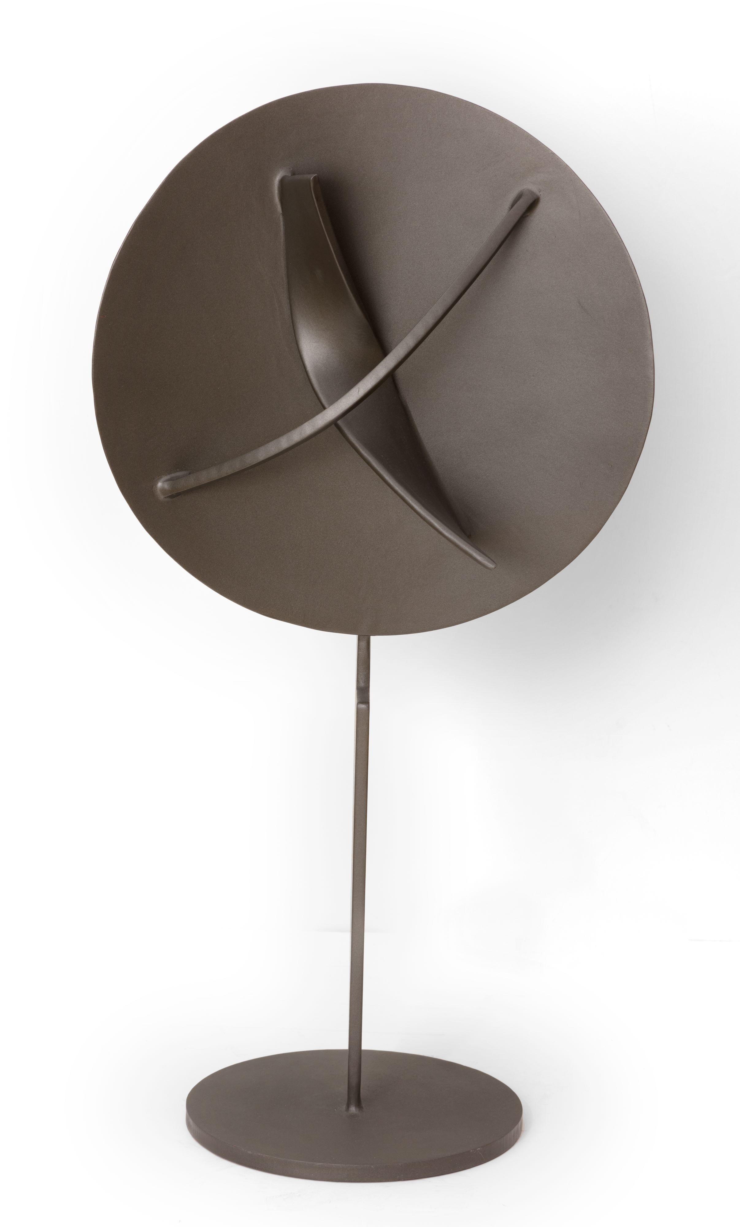 "Emerging Force" is a painted steel sculpture by Ralph Wickstrom created in 2000. From the front view, this sculpture appears to be simply a concave lens held up by a thin steel rod. It's only when the viewer explores the sculpture from all sides