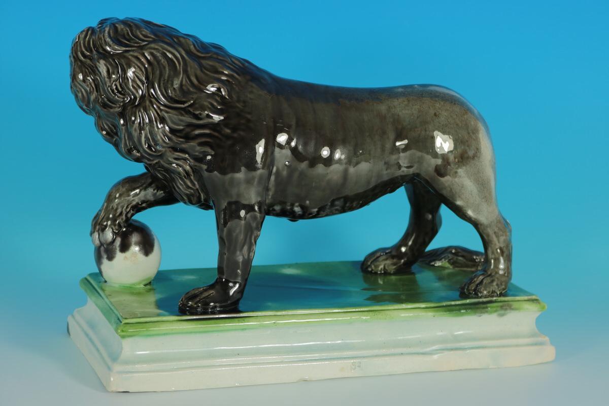 Ralph Wood Staffordshire pottery earthenware color glazed figure which features a Medici lion, stood on a plinth base. Decorated 'in the round', decoration to front and reverse. This piece represents the antique marble lions which stand at the