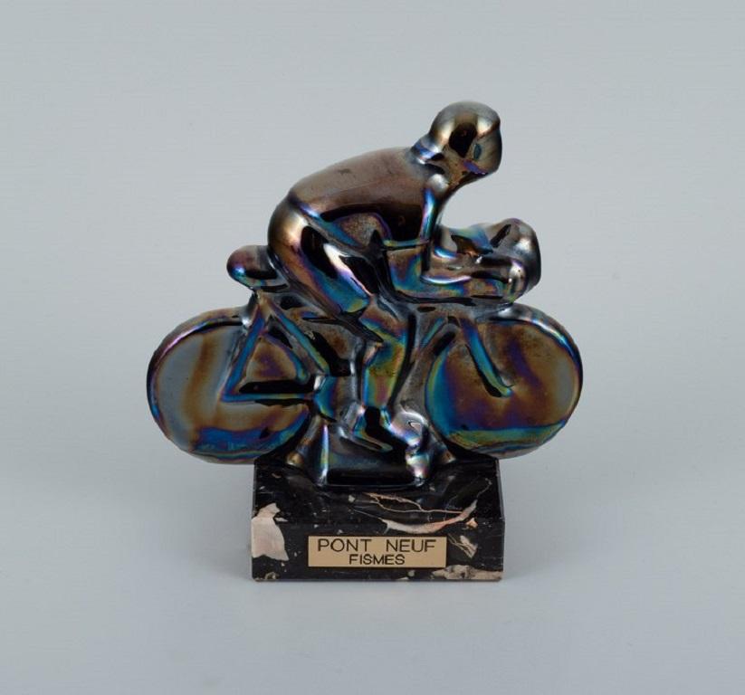 Rambervillers, a French ceramic sculpture in the form of a cyclist with beautiful eosin glaze.
