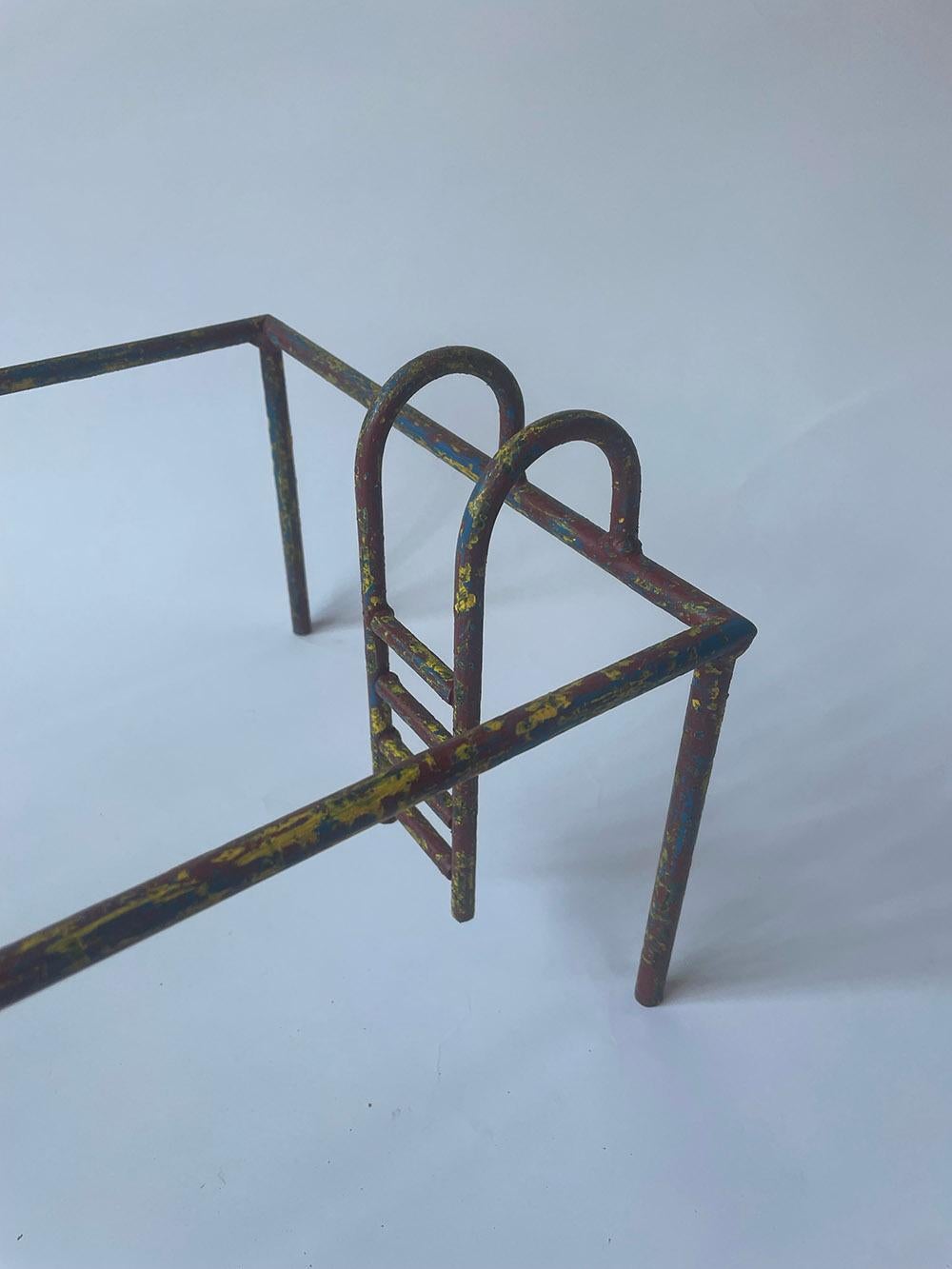 GRAND POOL is a unique sculpture by Spanish contemporary artist Ramon Enrich. 
Painted iron sculpture, oxidized patina and wax finish, 23 cm × 50 cm × 30 cm.
Halfway between a sculpture and a three-dimensional drawing, this artwork is full of irony