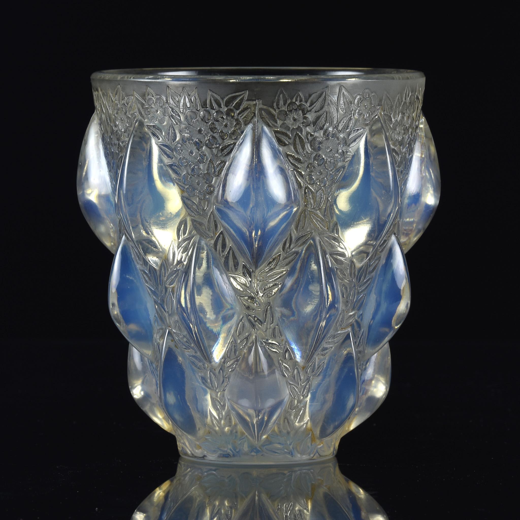 An exciting clear, frosted and opalescent Art Deco glass vase with raised lozenge pattern interspersed with flowering branches heightened with light staining, signed to base R Lalique France
 
Rampillon
Catalogue Number: 991
Signature