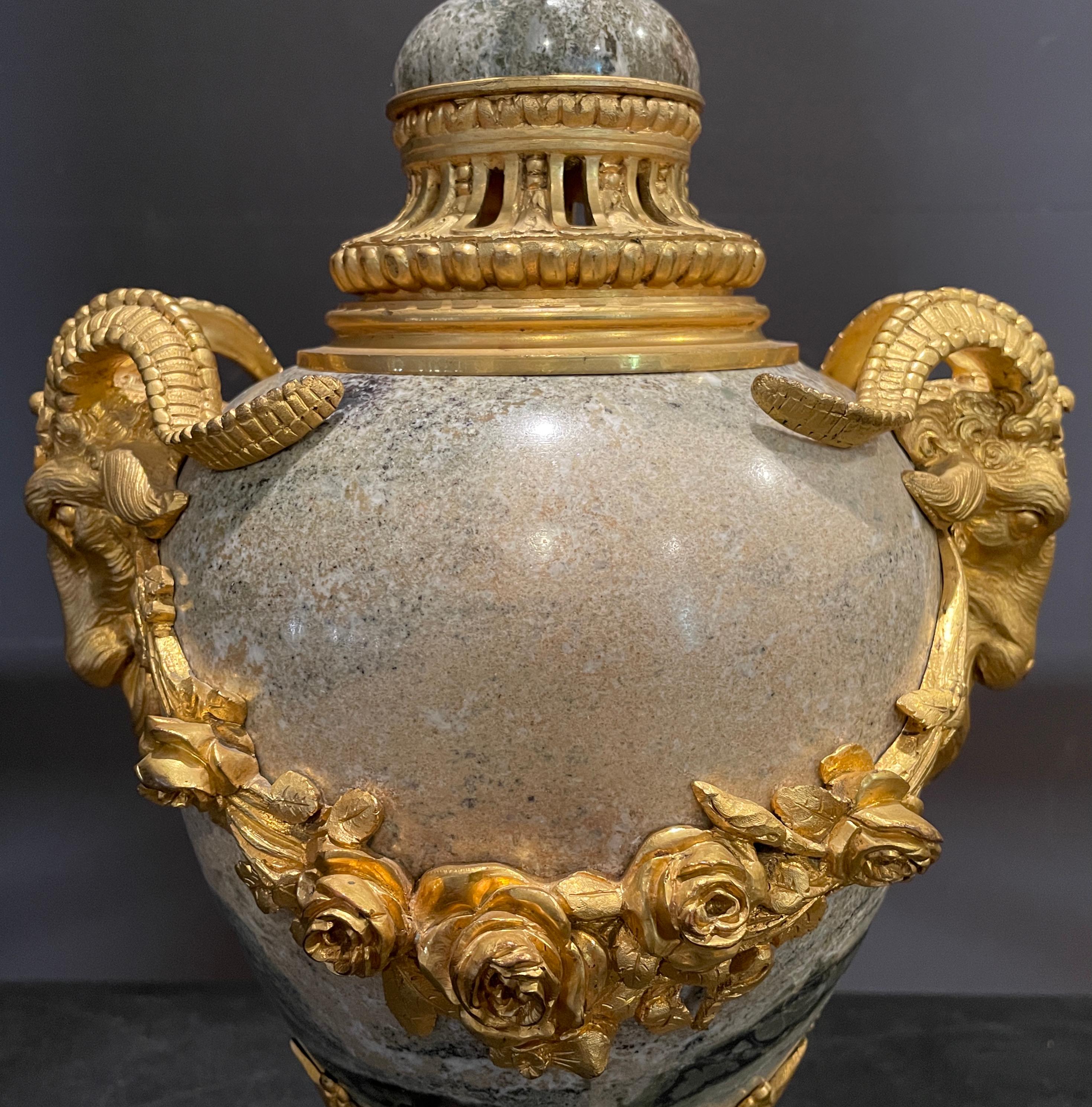 19th century Louis XVI gilt bronze mounted marble lamp with rams head and rose swag details.
19