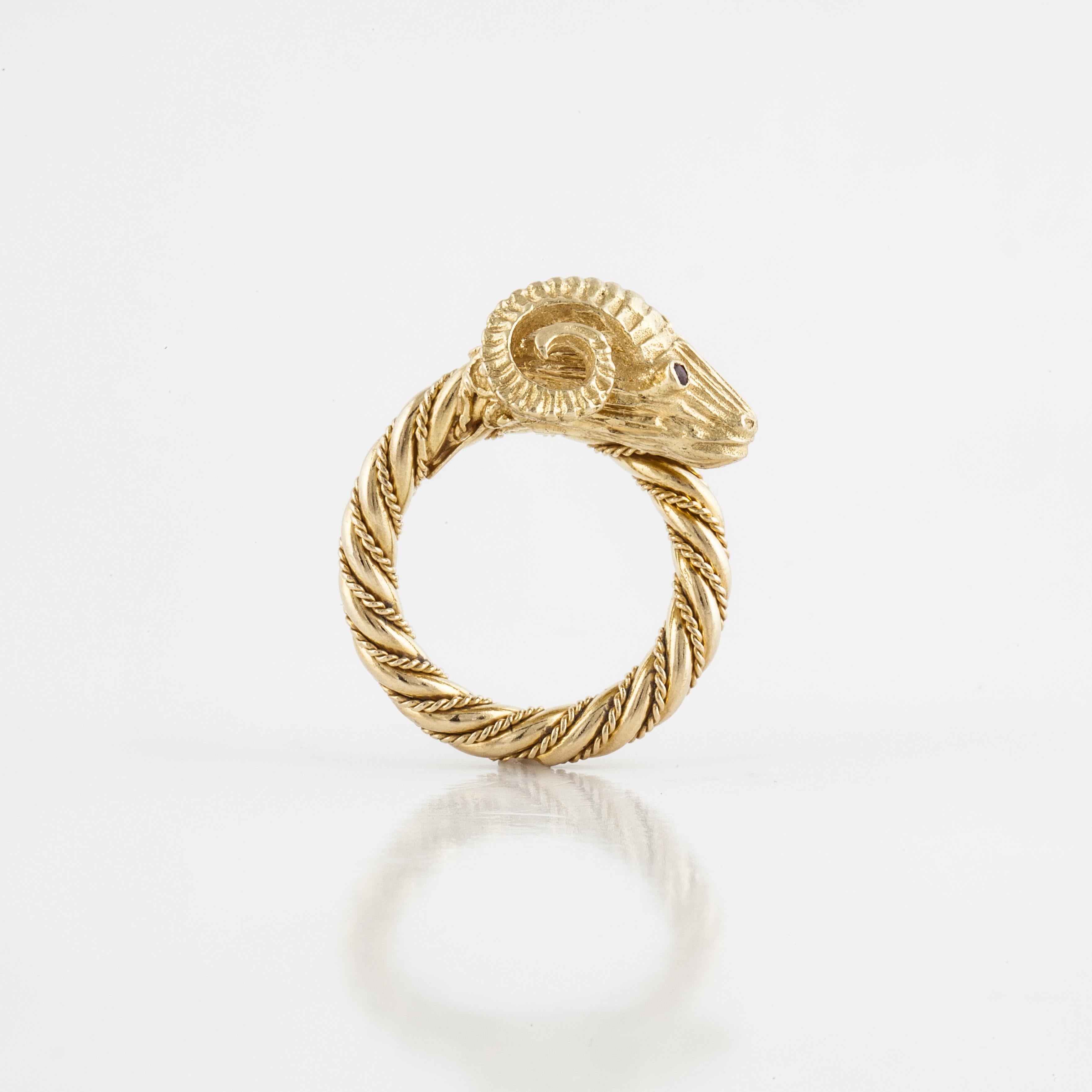 Rams head ring in 18K yellow gold with round ruby eyes. Beautiful detail with the twisted rope band and intricate gold work.  It measures 3/4 inches by 5/8 inches and stands 3/8 inches off the finger.  It is a size 6 and may not be sized.