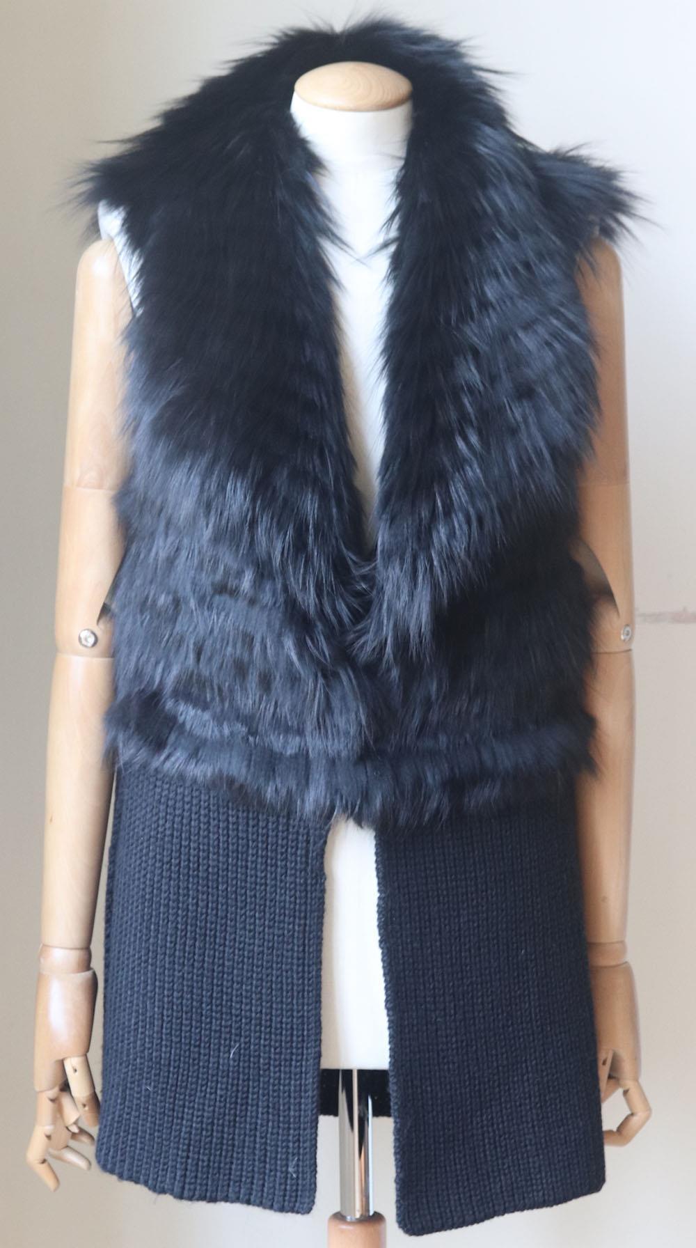 This Ramy Brook tactile fox-fur trimmed ribbed wool-blend vest is cut in a slighly loose fit for a layering piece, a perfect addition to your transitional wardrobe. Black fox-fur, black wool-blend. Concealed hook fastening at front. 100% Fox fur;