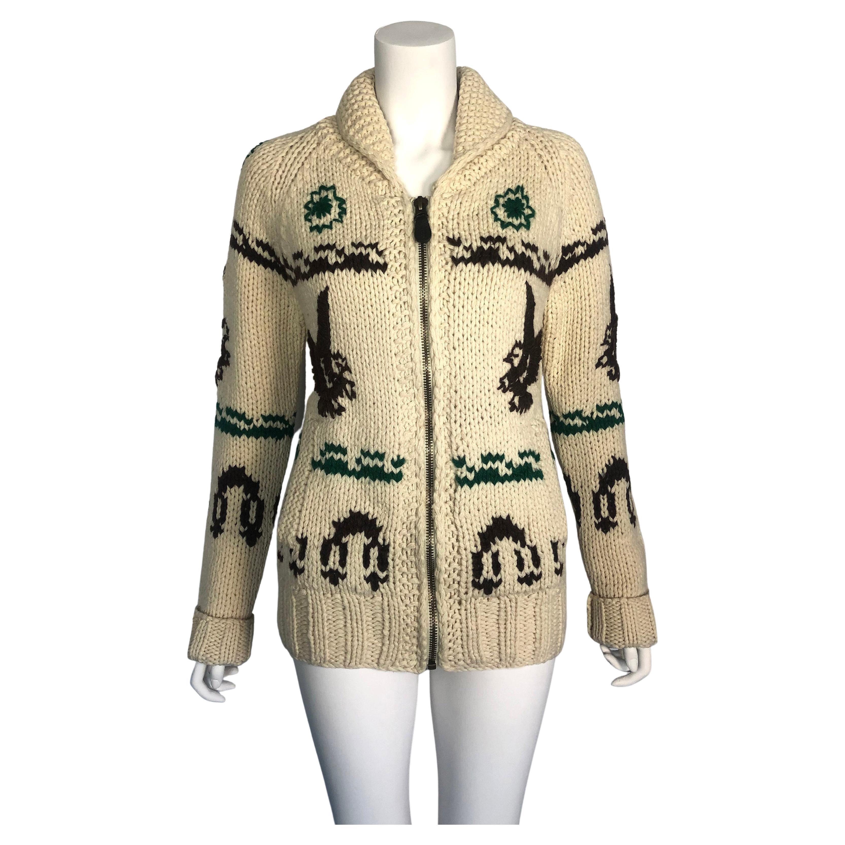 Product details:  RANCHER BY SCHOTT - Chunky Knit Cardigan  - Brown Knitted Eagle Motif Throughout - Dark Green Floral Motifs - Front Zipper Fasten - Leather Zip Pull Detail - Shawl Collar - x 2 Front Pockets - Turn Up / Down Cuff Detail
Era: 1990s