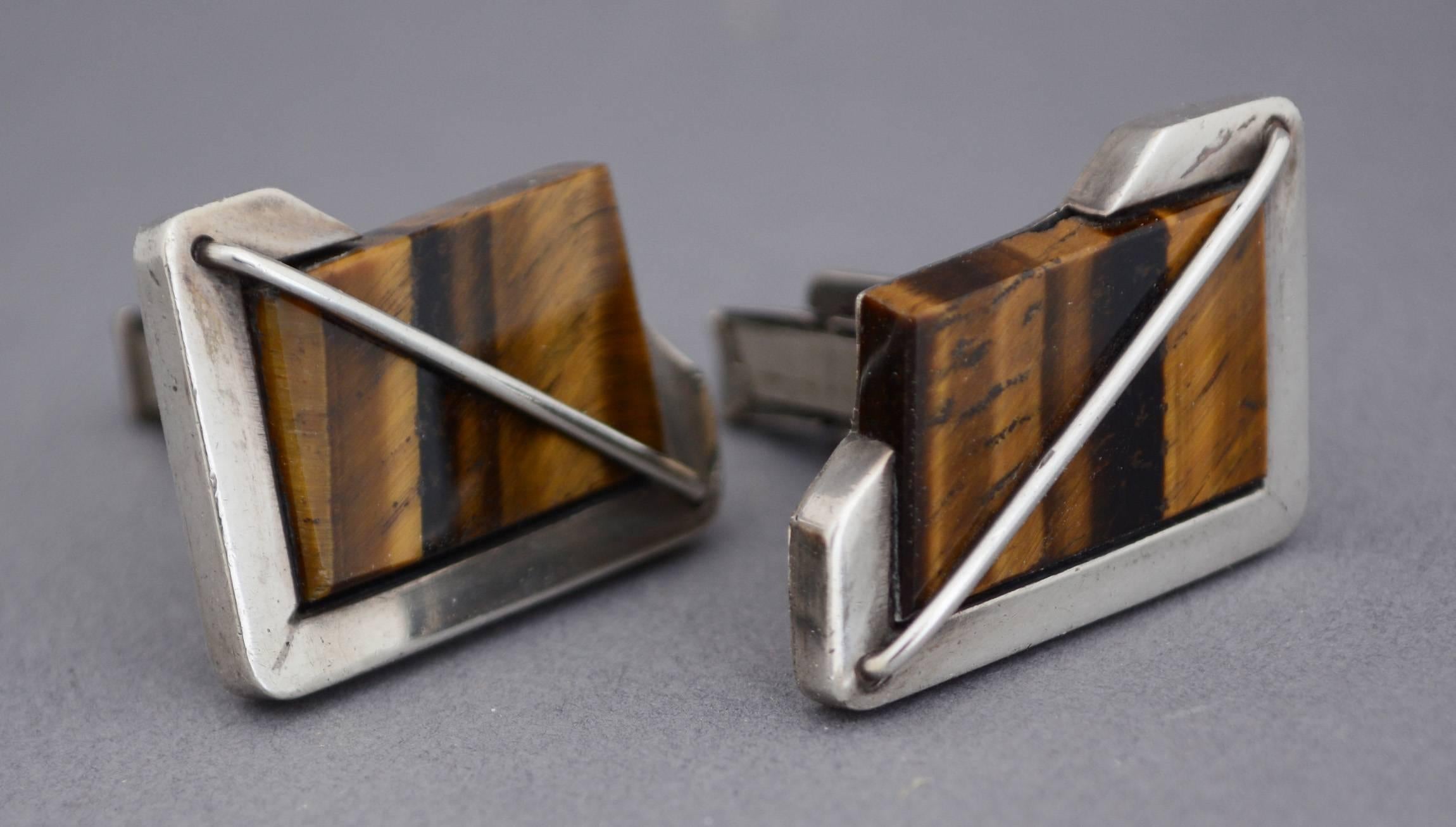 Sterling and tiger eye cufflinks with an asymmetrical modernist design. These were made by the Rancho Alegre shop in Taxco, Mexico.