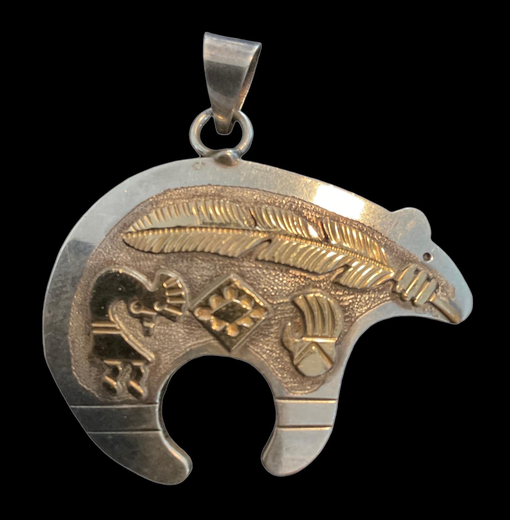 This Randall Begay Sterling Silver 1/20 12k Gold Filled Bear With Kokopelli Pendant was beautifully made and is heavier than most in this style. The Begay family has a long line of silversmiths, each of whom made a name for themselves. Randall is a