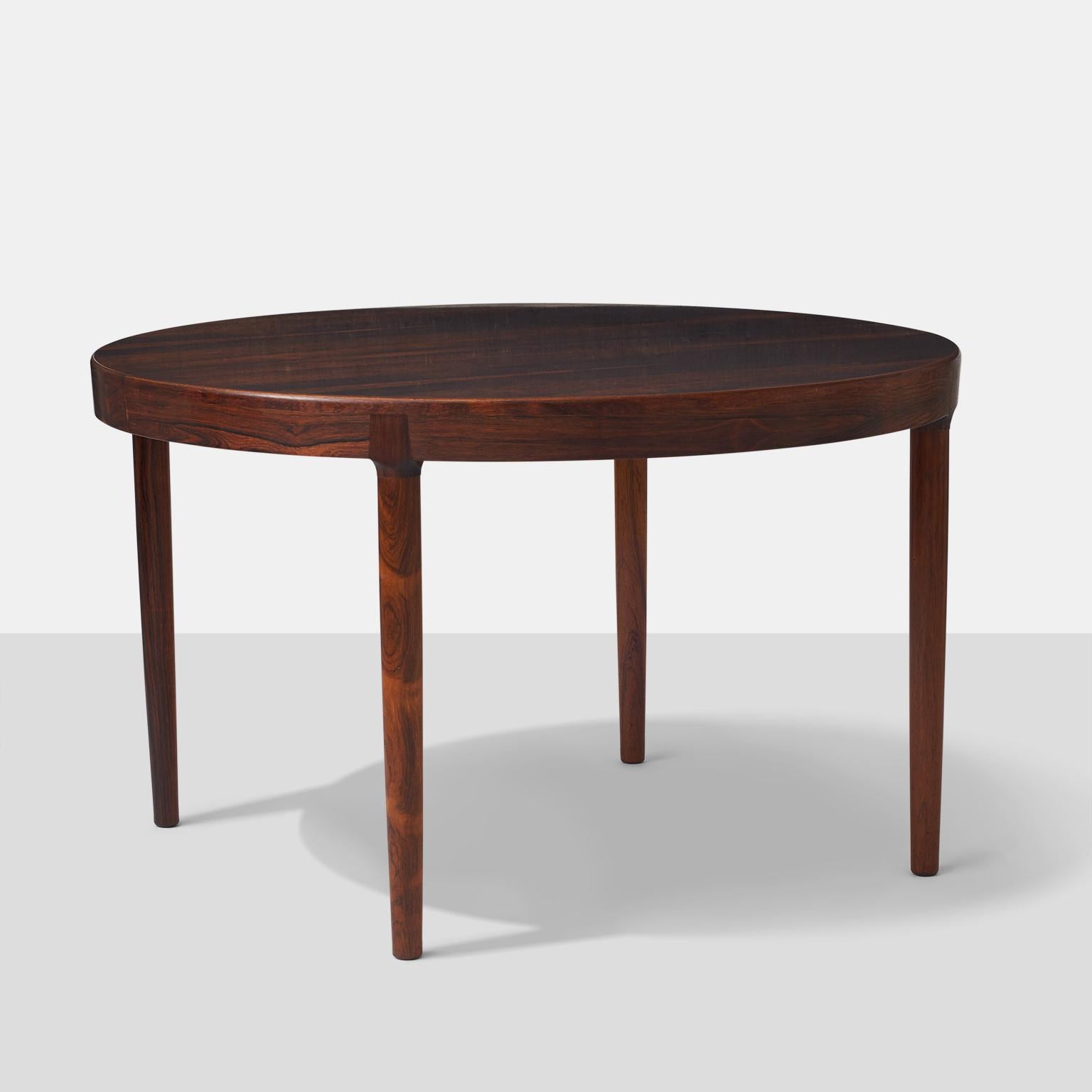 A round dining table in Brazilian rosewood with four legs. 2 leaves included. Attractive joint where the legs meet the apron.

Leaves add 19.5